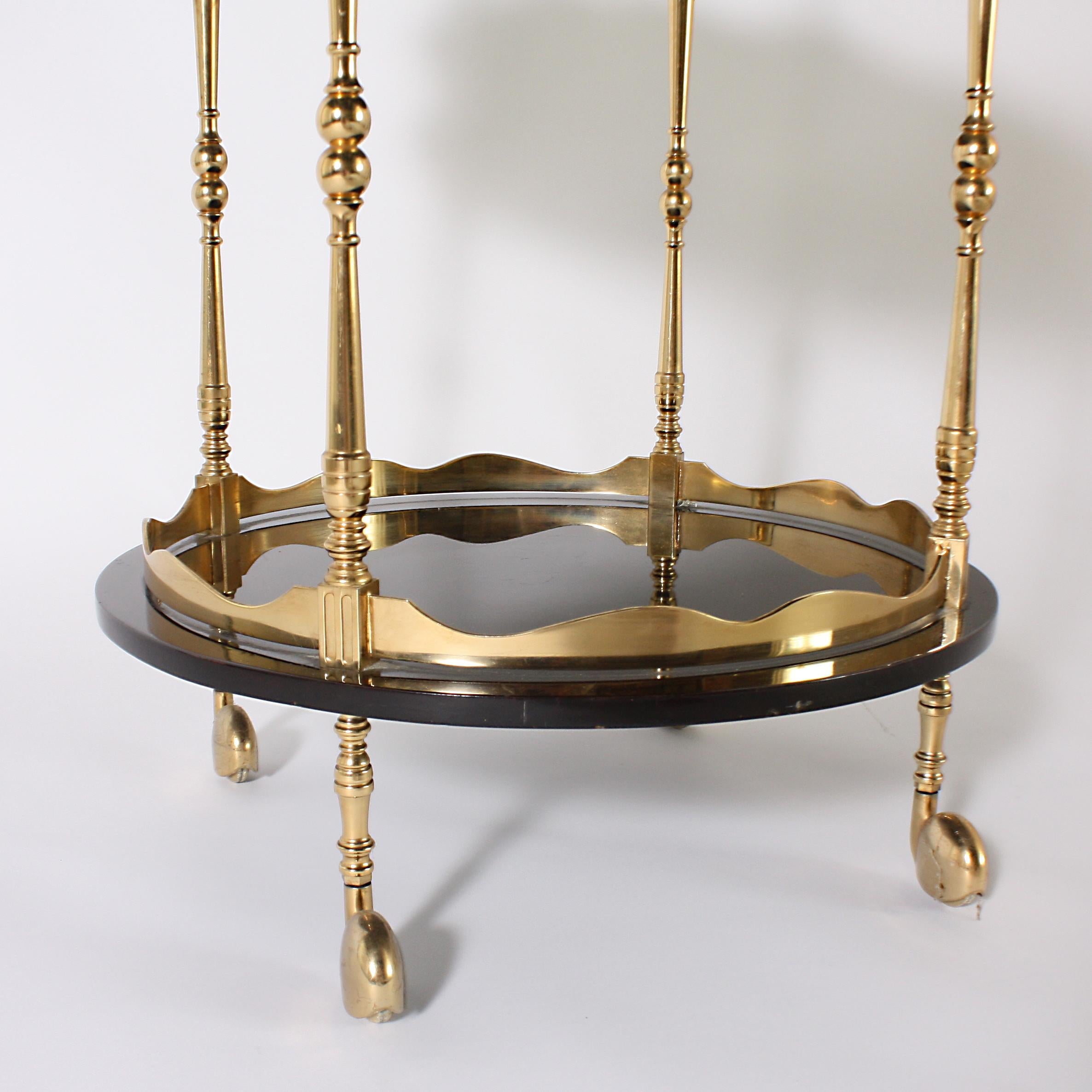 Round lacquered bar cart with brass details, circa 1970.