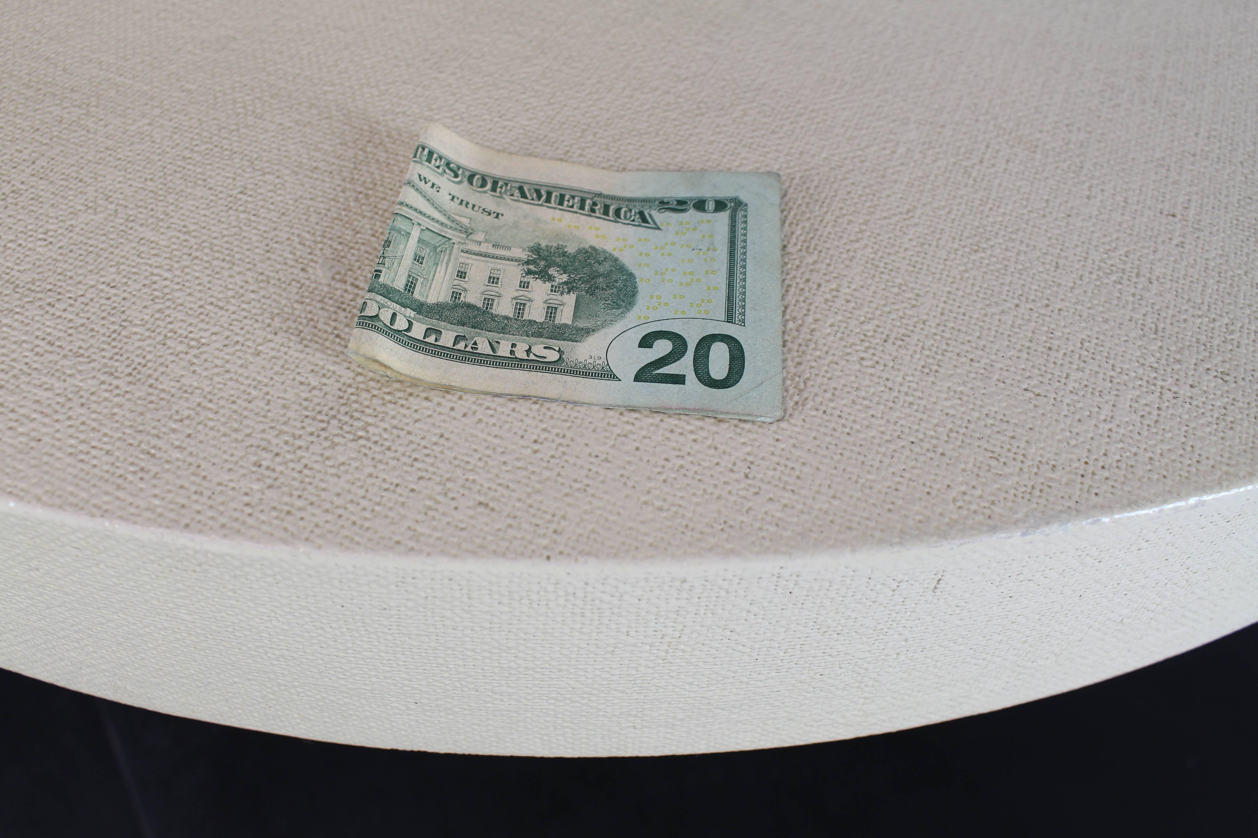 Cylinder shape base and pancake top lacquered cloth coffee table.