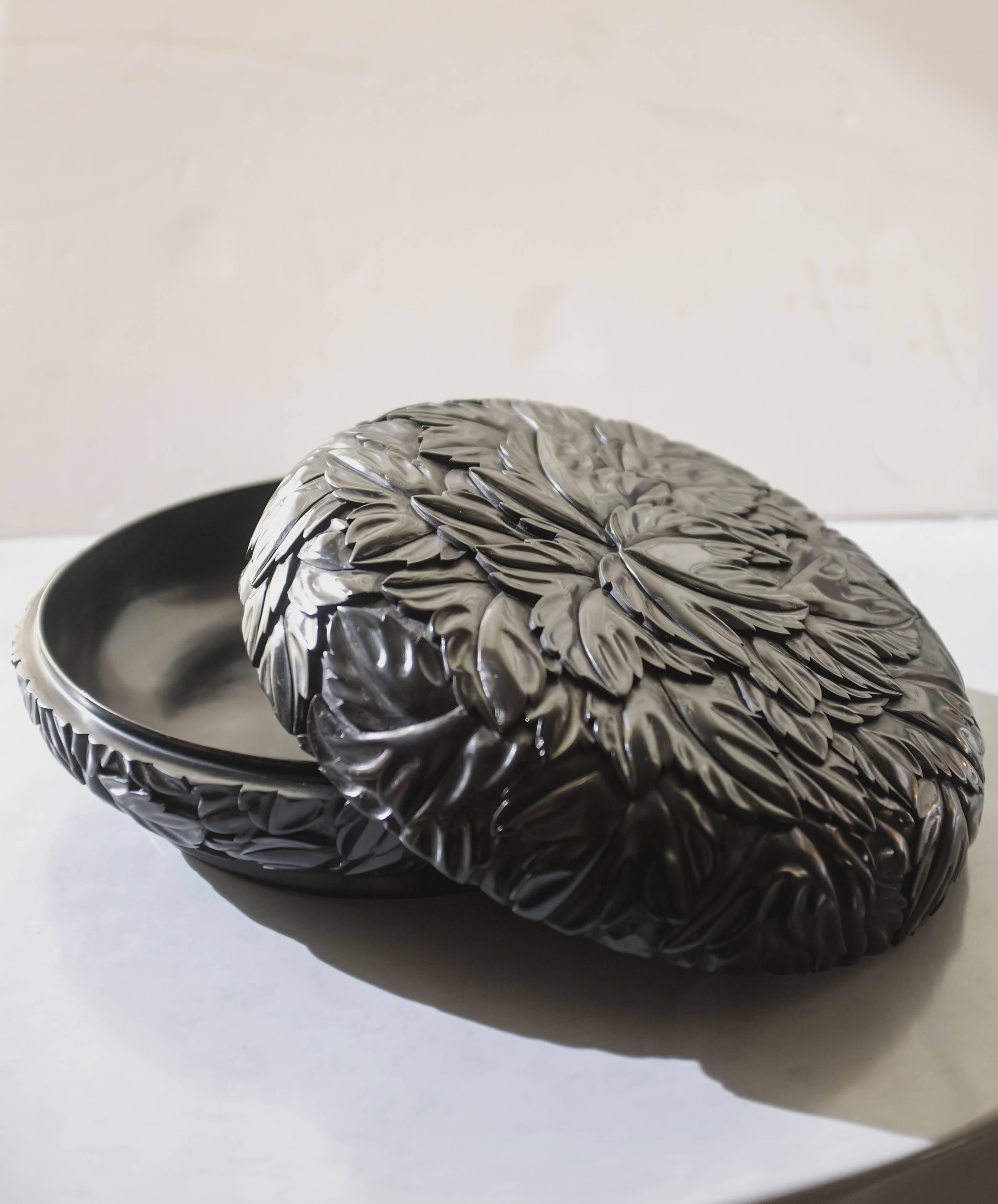 Round leaf design box
Black lacquer
Hand-carved
Wood base
Limited edition
In stock.

Lacquer is a technique that dates back to the Shang dynasty, circa 1600-1100 B.C. These pieces are made with at least 60 coats of organic lacquer. Each layer of