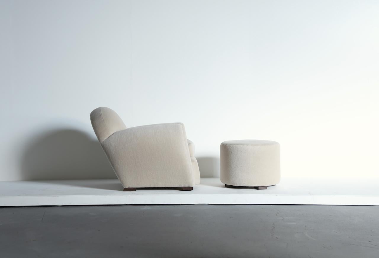 Superb round, leaning, modern club chair, upholstered in pure Alpaca, with a matching ottoman.  High quality handmade beech frames and upholstered in a soft, ivory, premium 100% alpaca wool fabric.   Handmade in England.   Pairs are also available -