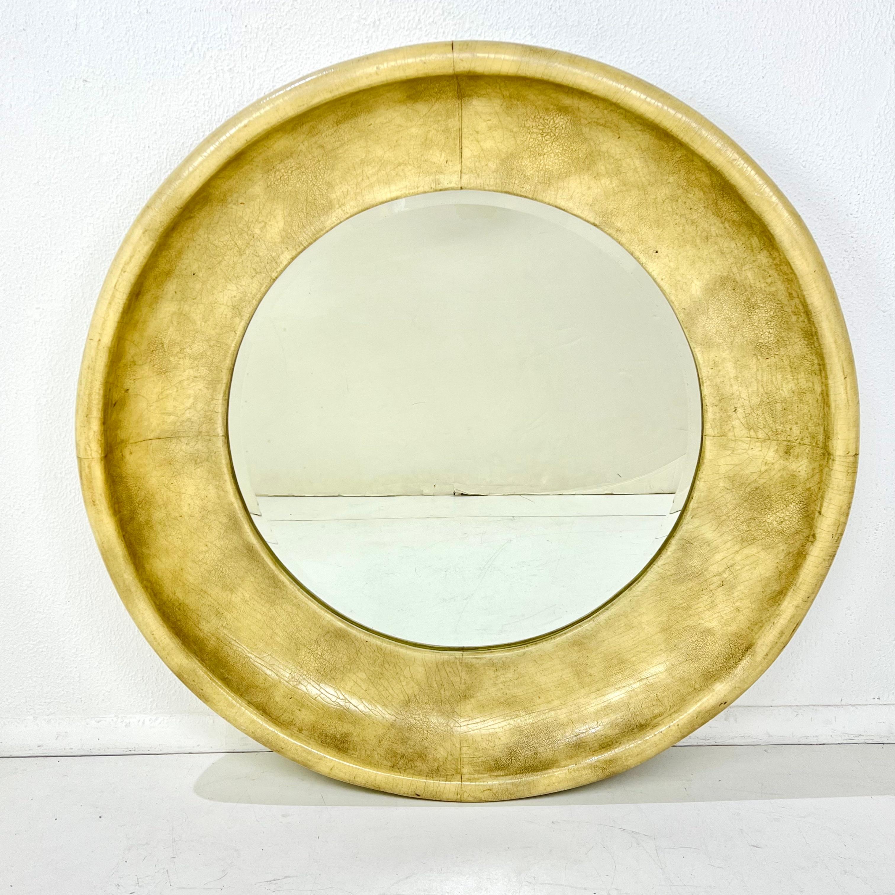 Glamorous 1980’s round aged leather beveled mirror by Maitland Smith. Constructed of wood and covered with an aged leather trim and beveled mirror. Good condition, shows some minor wear consistent with age. Retains Maitland Smith label on
