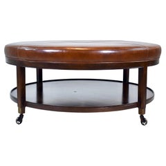 Pouf rond en cuir sur roulettes en laiton