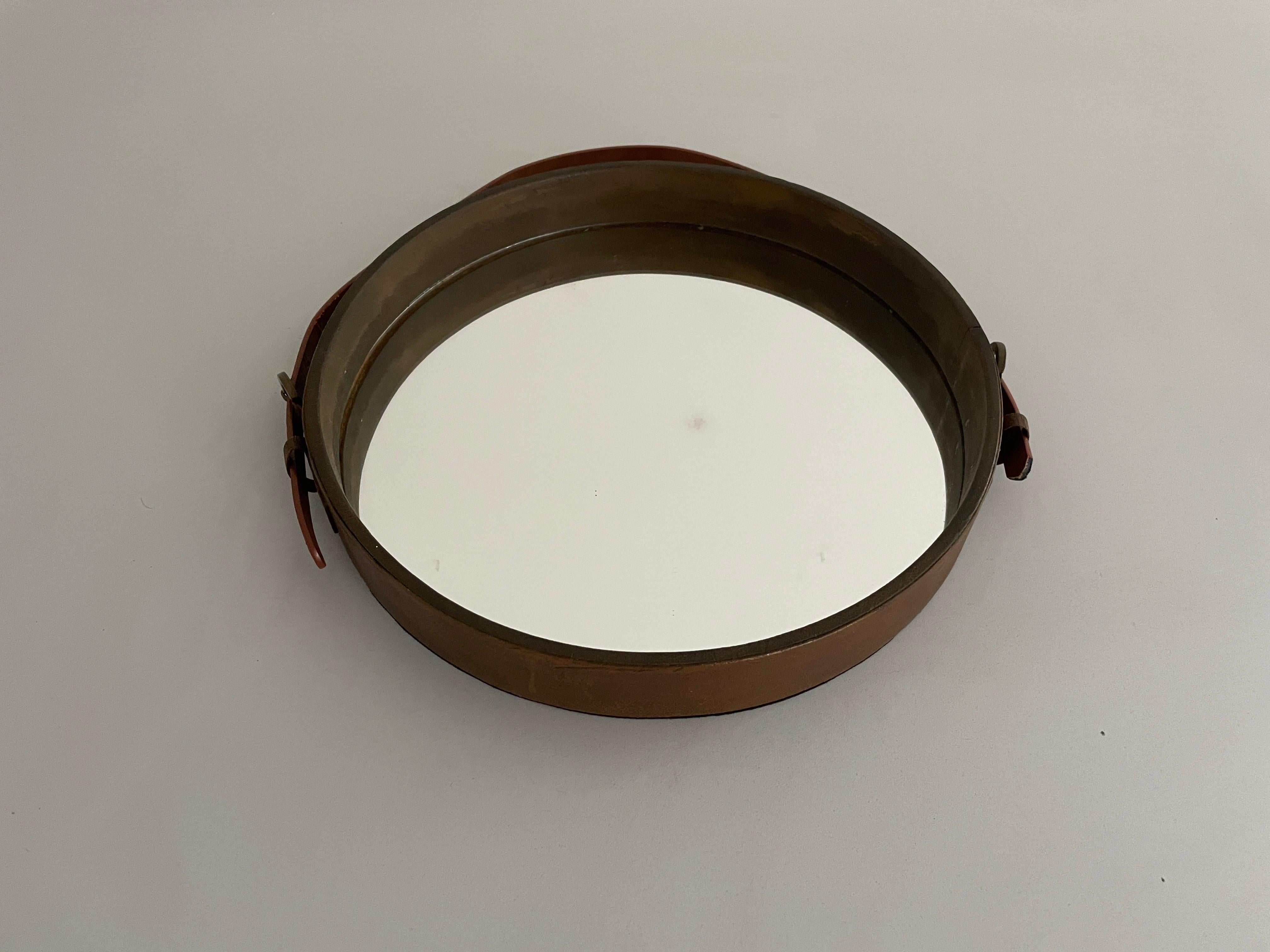Round Leather Wall Mirror with Leather Strap, 1960s, Italy

It is very ideal and suitable for all living areas.

No damage, no crack.
Wear consistent with age and use.

Measurements: 
Diameter: 30 cm
Depth: 4 cm