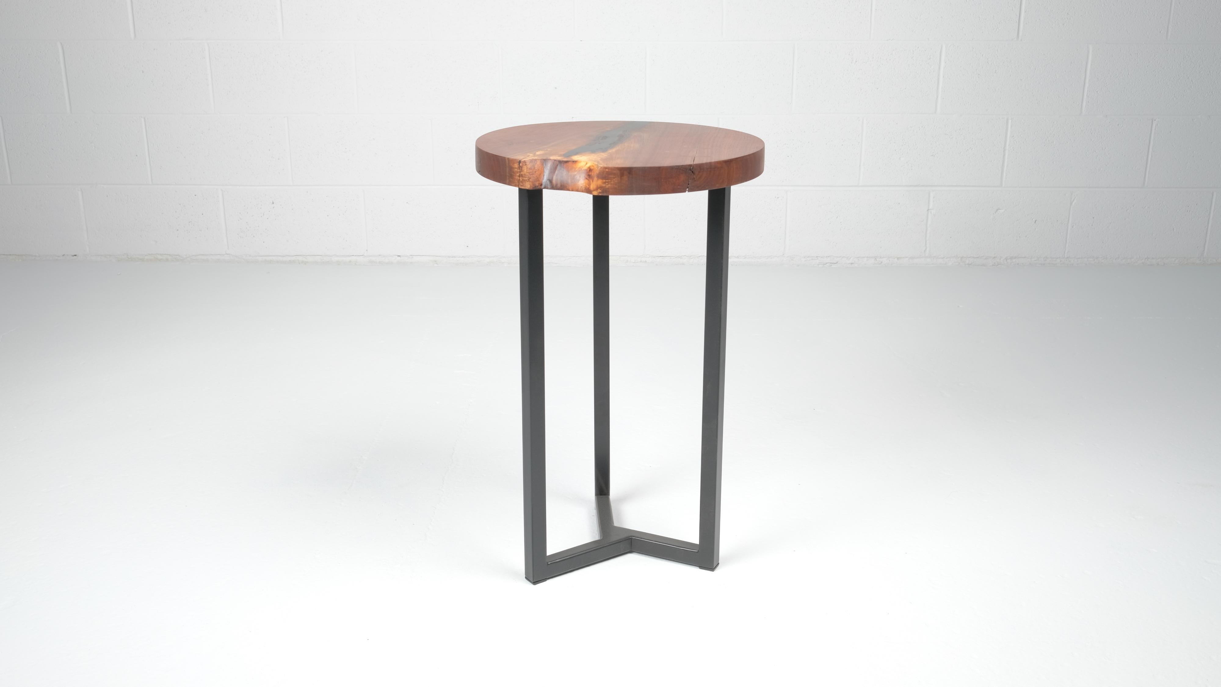 This round end table features subtle walnut 