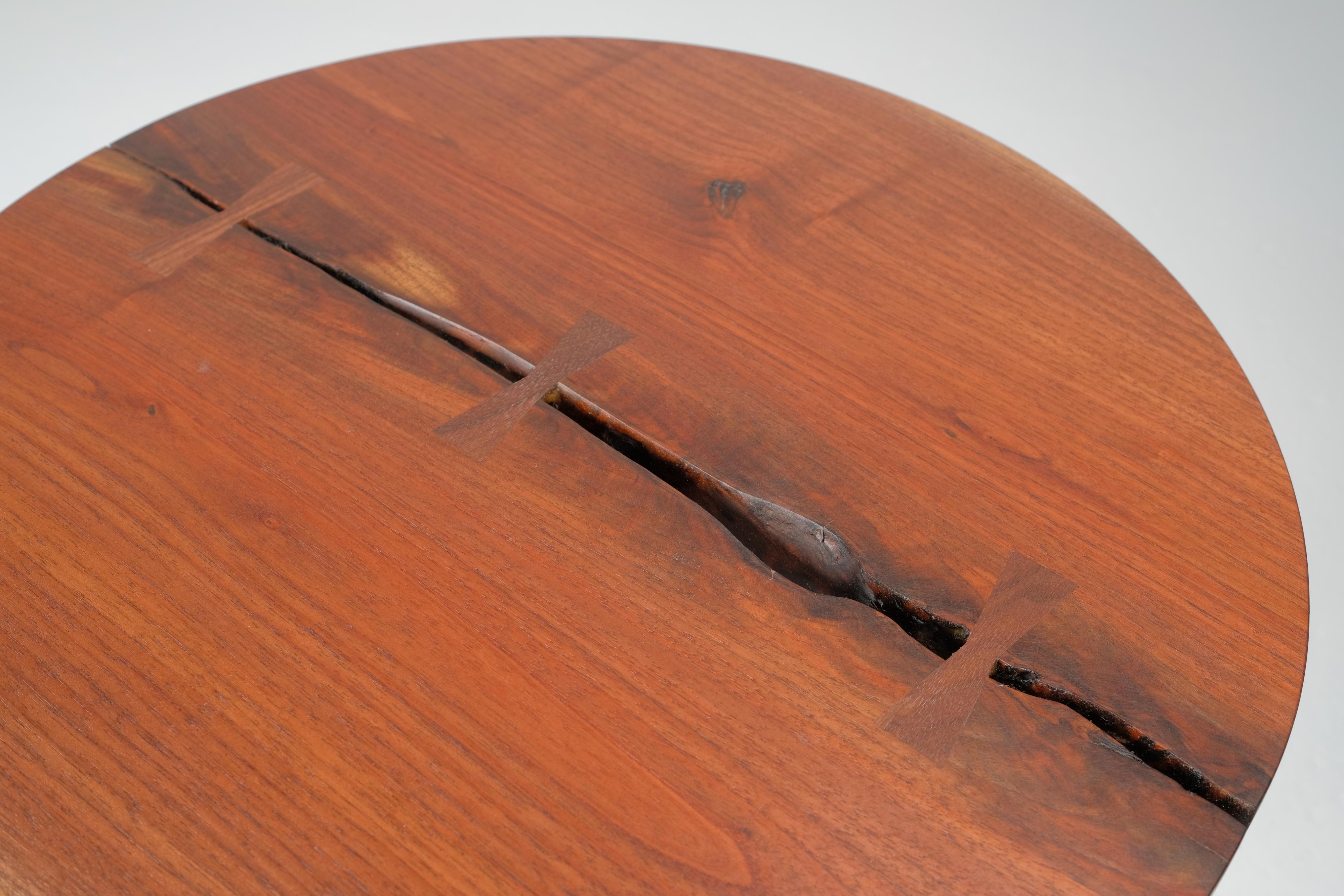 This round end table features subtle walnut 