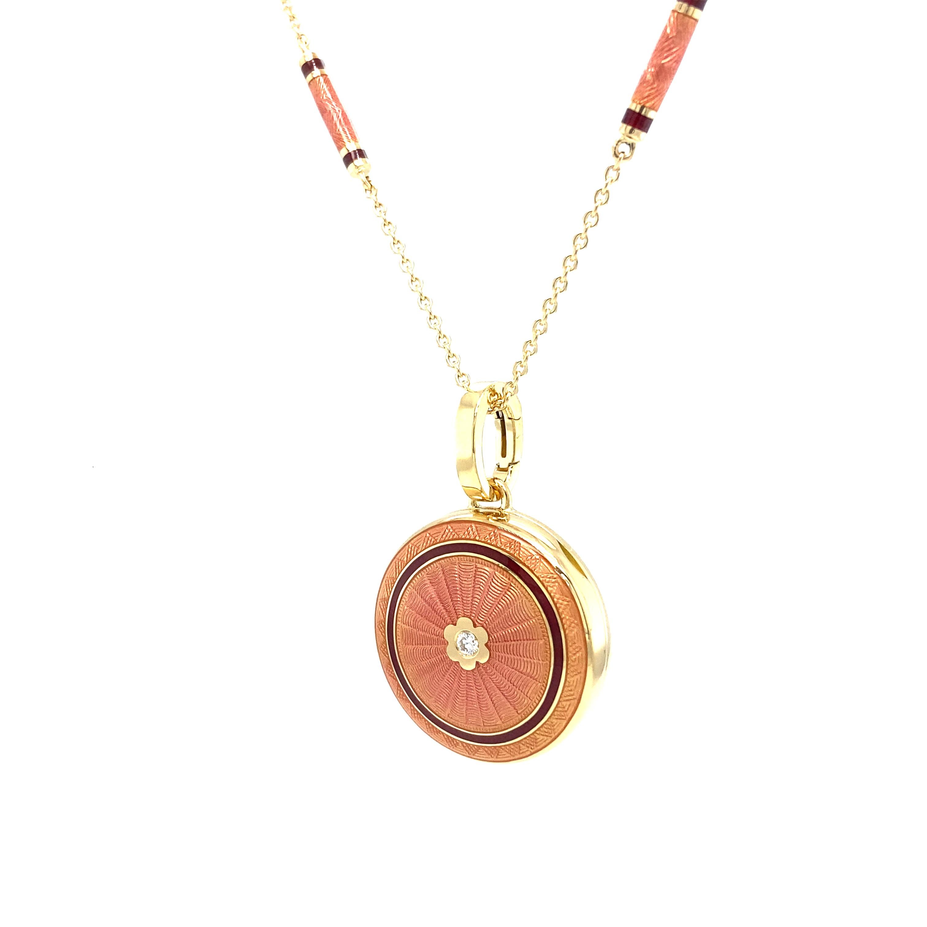 Victor Mayer round locket pendant in 18k yellow gold with pink and burgundy red vitreous enamel and 1 brilliant cut diamond 0.03 ct, H VS

About the creator Victor Mayer 
Victor Mayer is internationally renowned for elegant timeless designs and
