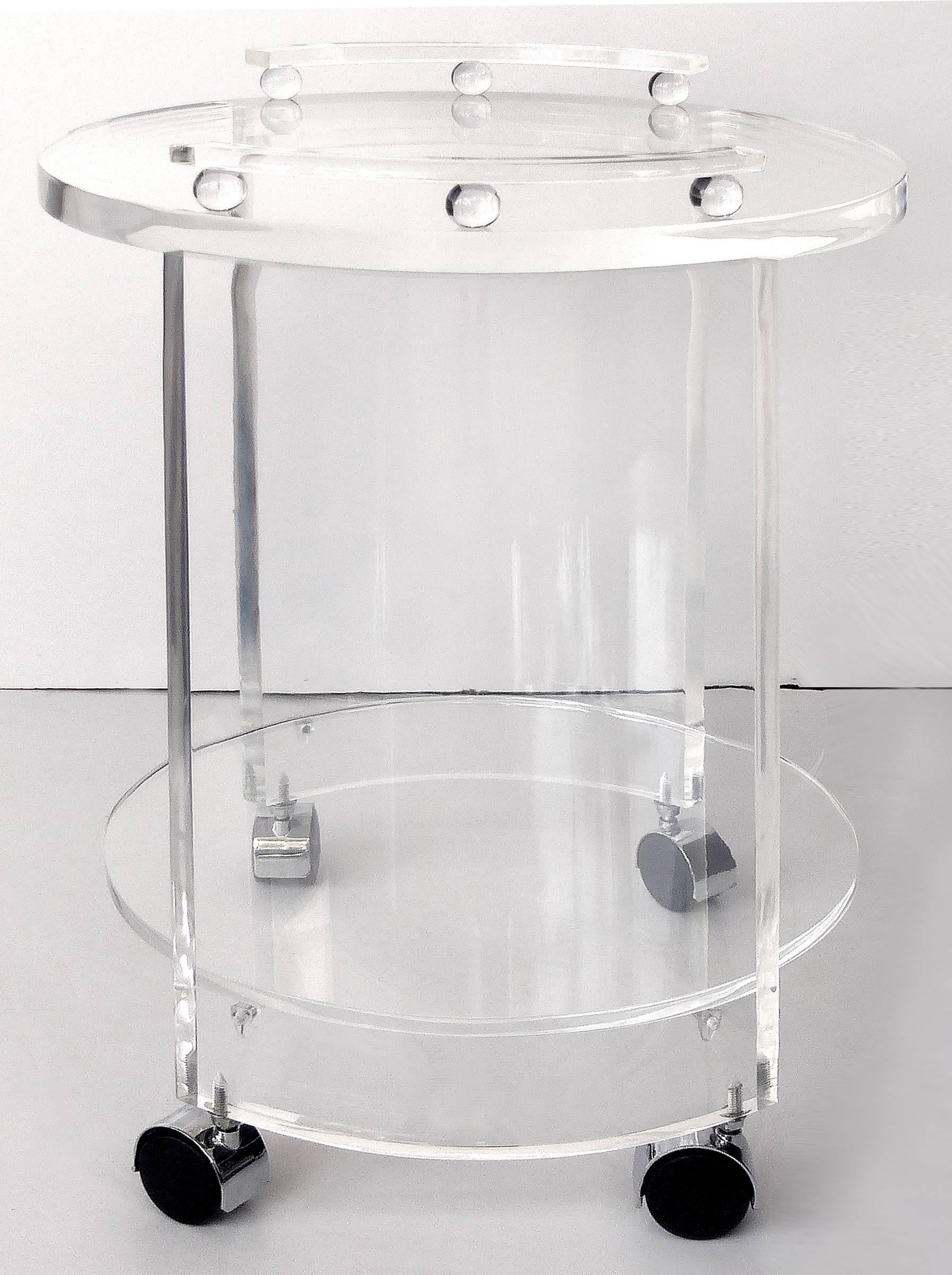 Round Lucite Bar Cart on Casters

Offered for sale is a two-tiered round Lucite bar cart. Custom made by Iconic Design, these carts can be customized.