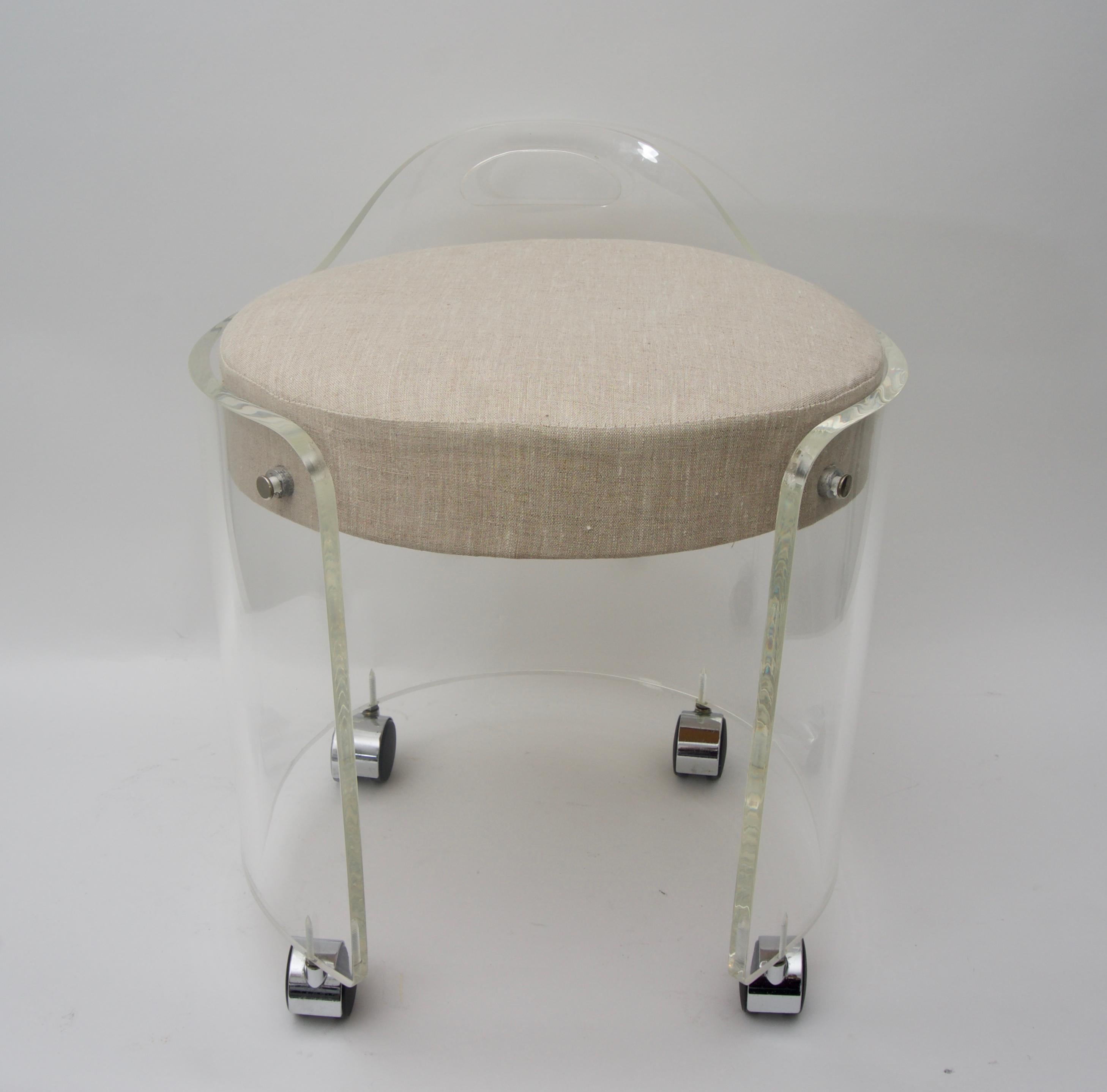 This stylish Lucite vanity chair is by Charles Hollis Jones and dates to the 1970s and has been professionally polished and reupholstered in a woven linen fabric.