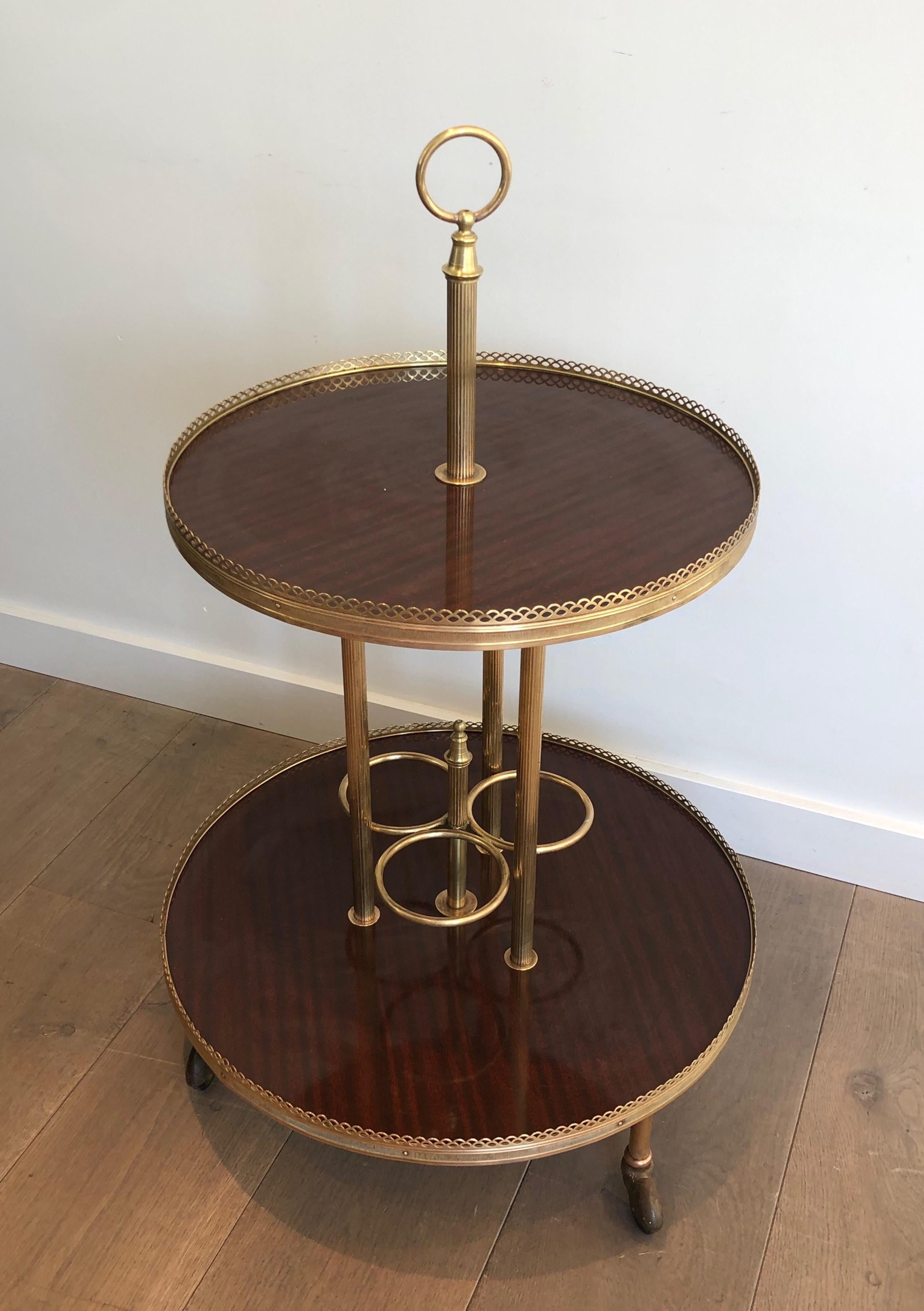 This unusual round drinks trolley is made of mahogany and brass. This is a French work attributed to Maison Jansen. Circa 1940