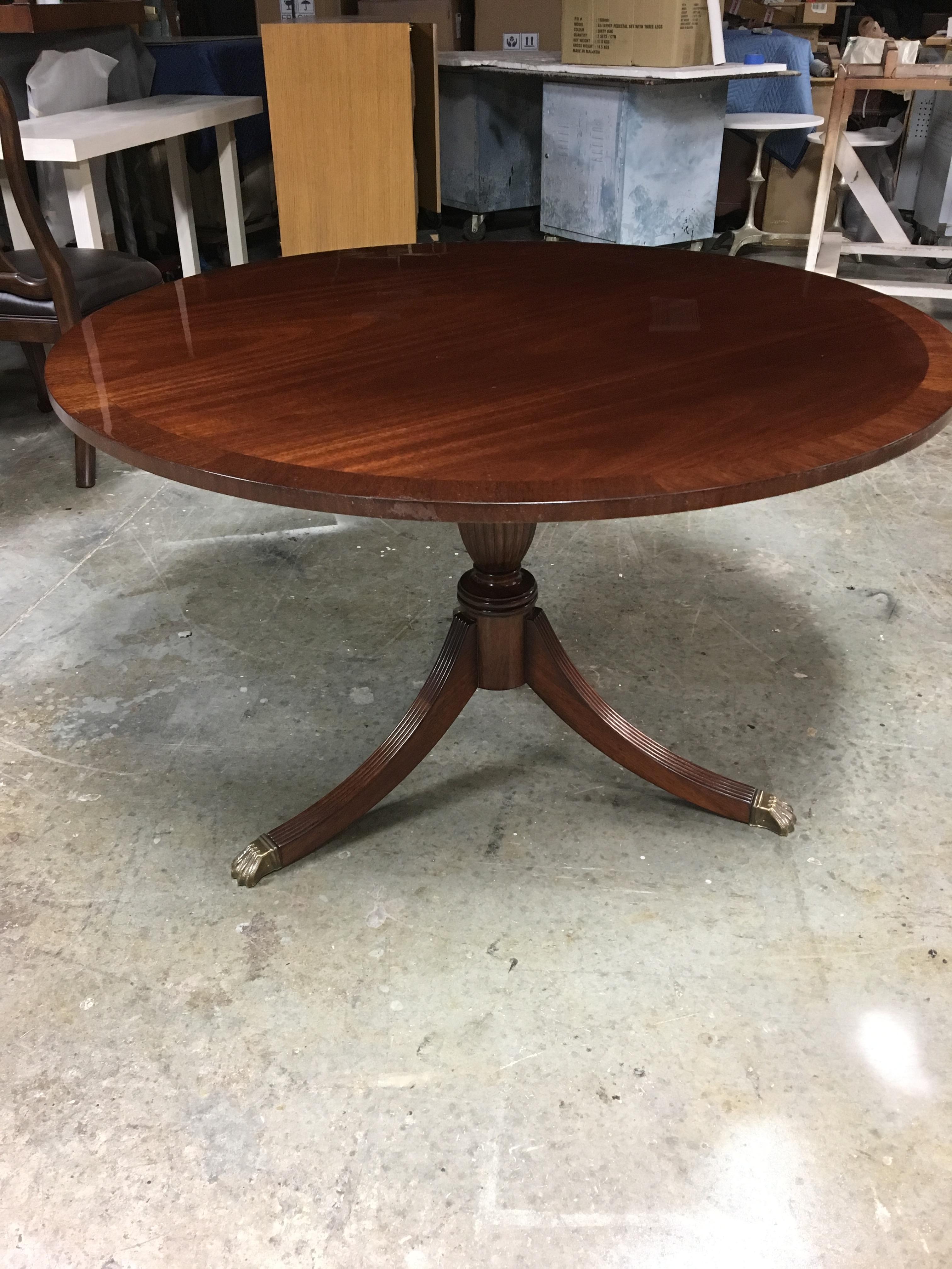 This is made-to-order round traditional mahogany accent/foyer table made in the Leighton Hall shop. It features a field of cathedral mahogany and a border of straight grain mahogany. It has a hand rubbed and polished semigloss finish. The pedestal