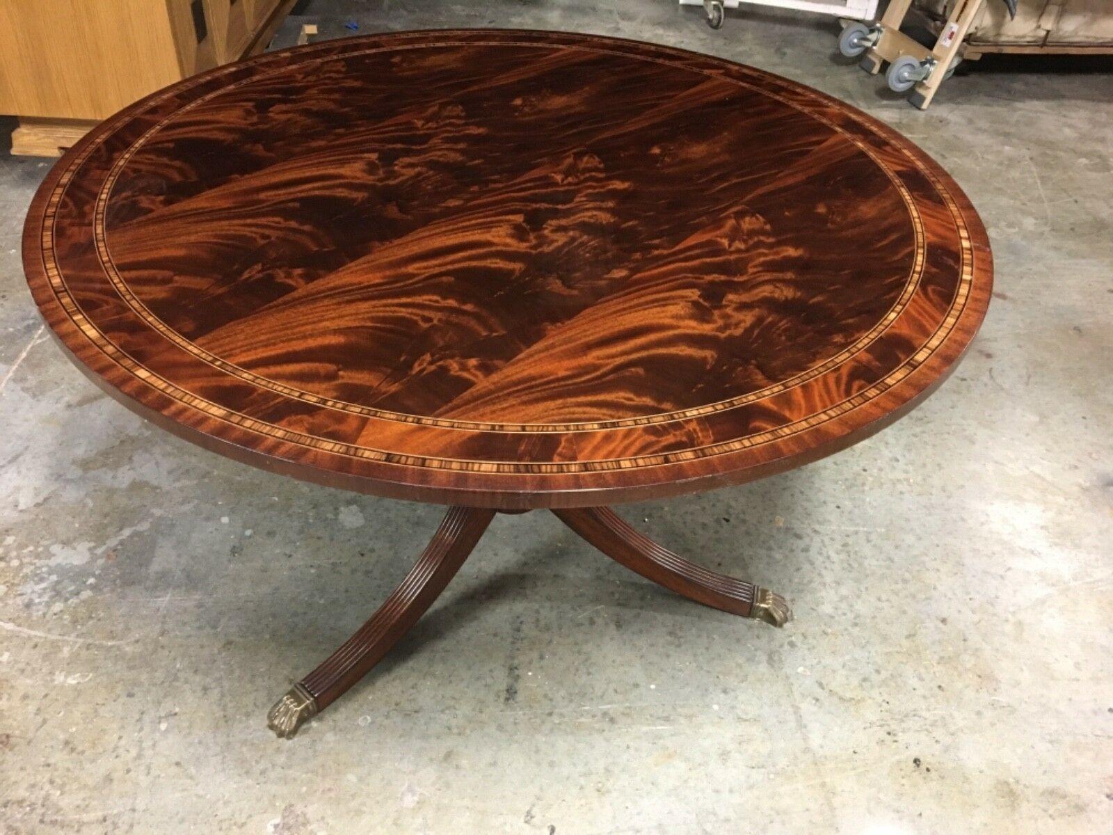 This is a made-to-order round traditional mahogany accent/foyer table made in the Leighton Hall shop. It features a field of crotch mahogany and borders of crotch mahogany and straight grain mahogany with inlays of Zebra wood. It has a hand rubbed
