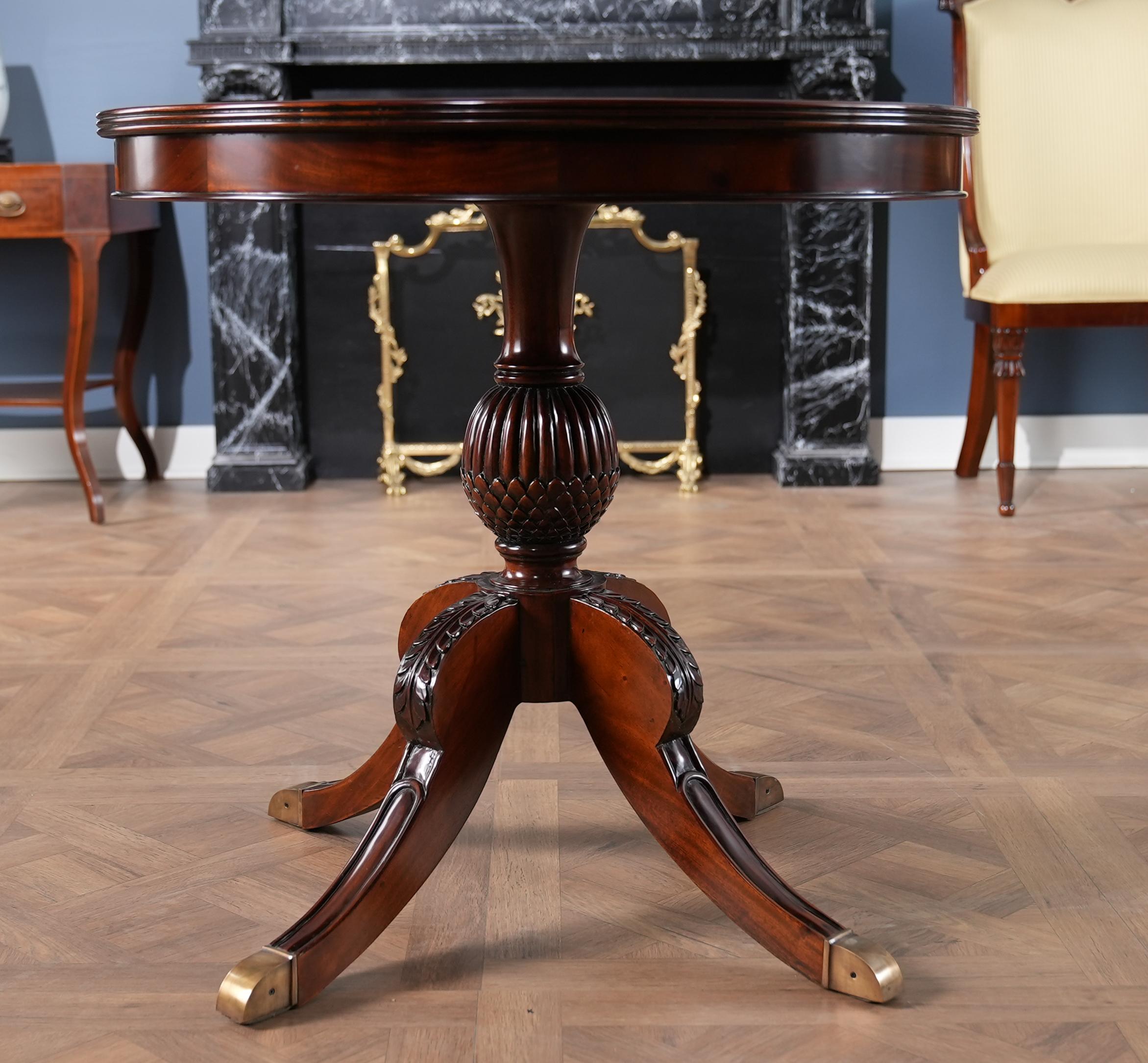 The elegant and refined Round Mahogany Pineapple Table from Niagara Furniture boasts a fantastic base carved to resemble the shape of a pineapple as well as a beautiful mahogany skirted top with a satinwood banded edge. The top portion of the Round