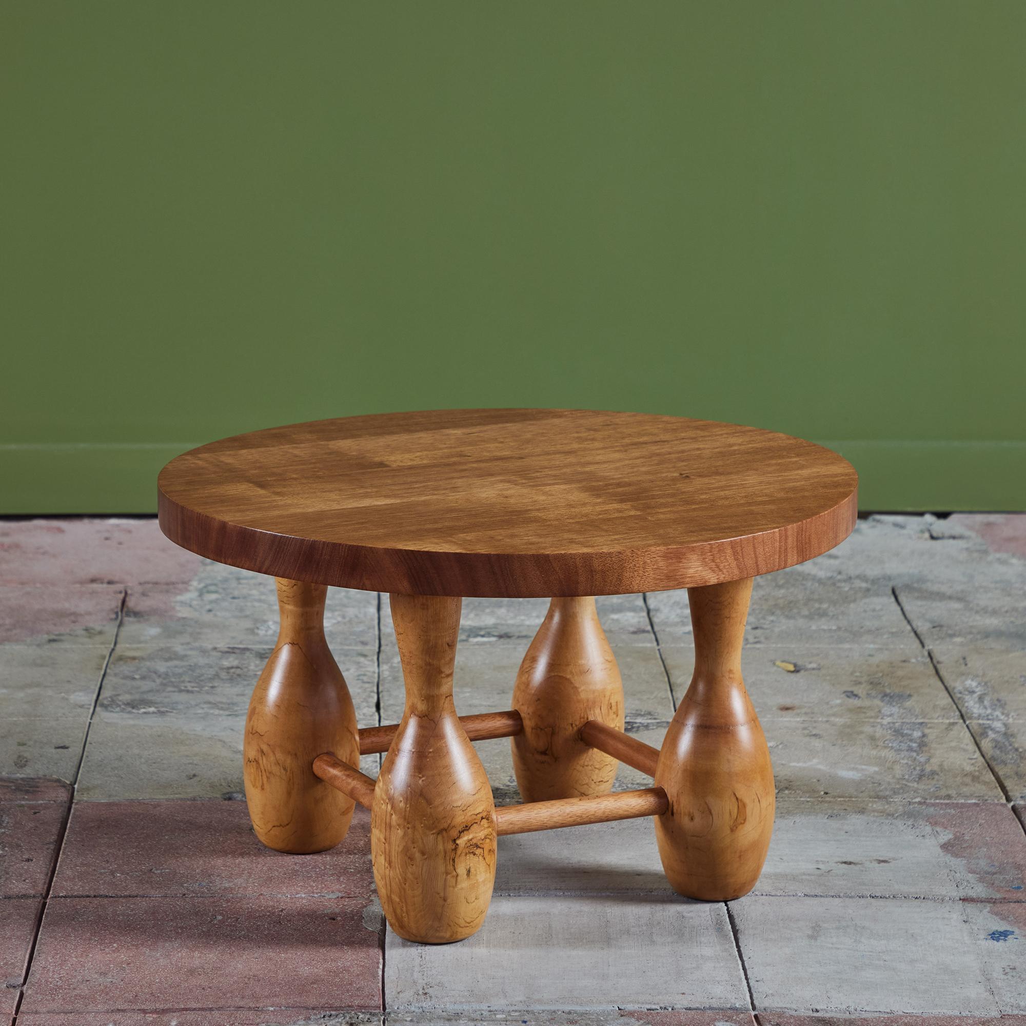 Solid mahogany slab top side table with playful curvy oak legs. This piece features a thick round table top supported by four hand turned legs connected by four stretchers.

Dimensions
25.25
