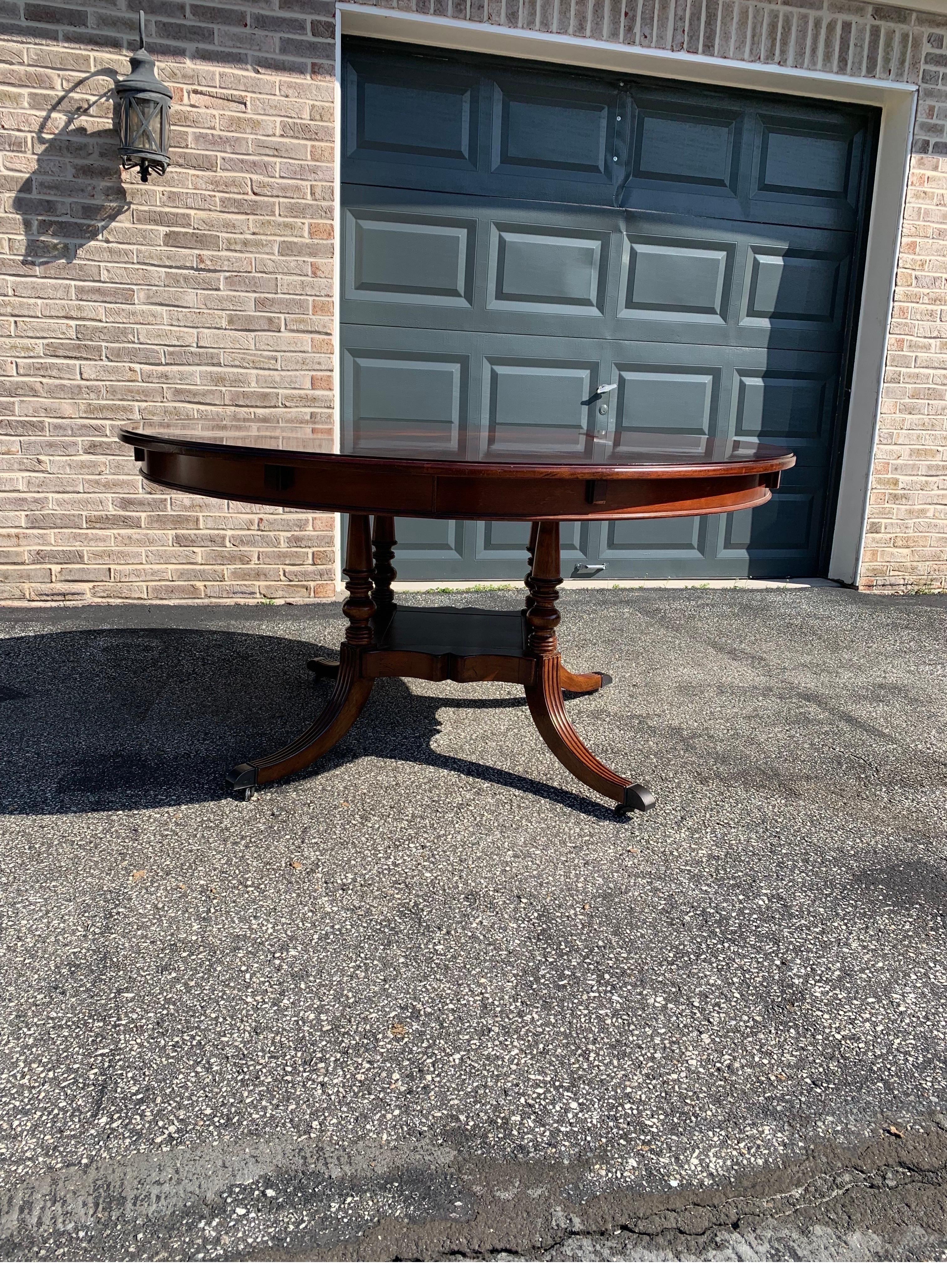 A 60” round perimeter dining table produced with high quality mahogany. Surrounding the top can be placed four leaves which rest on pullout slides and are fastened in place with metal locking mechanisms to give the table an overall diameter of 78”.