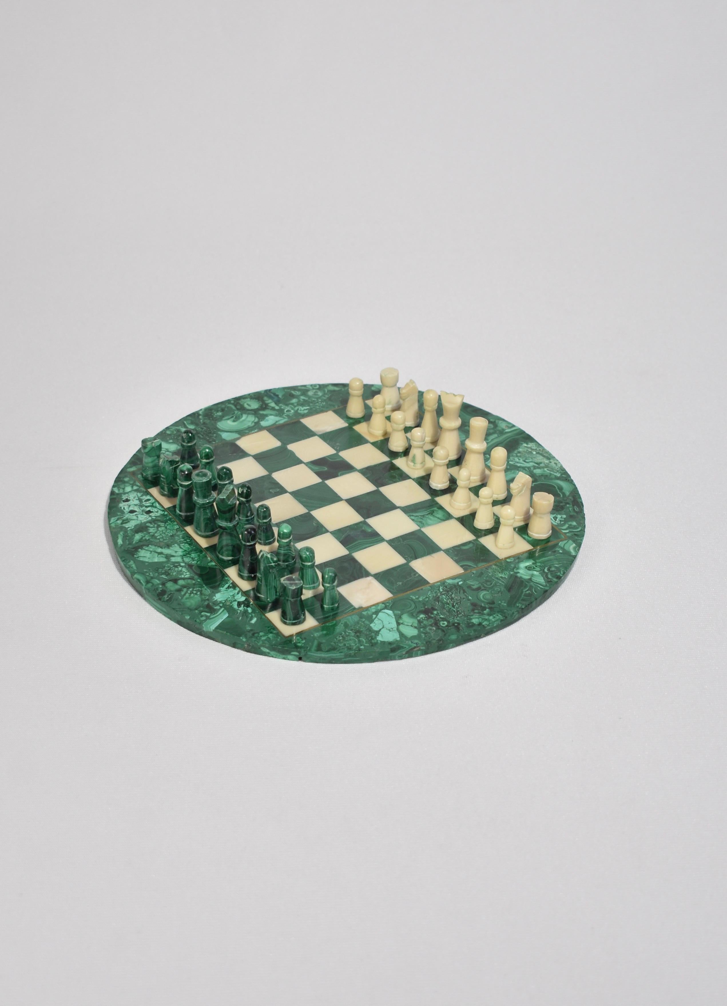 Rare, small round malachite chess board with hand carved pieces in malachite and off-white stone, accented in brass inlay. Includes all 32 pieces. 

Dimensions: 
Board measures 8.75