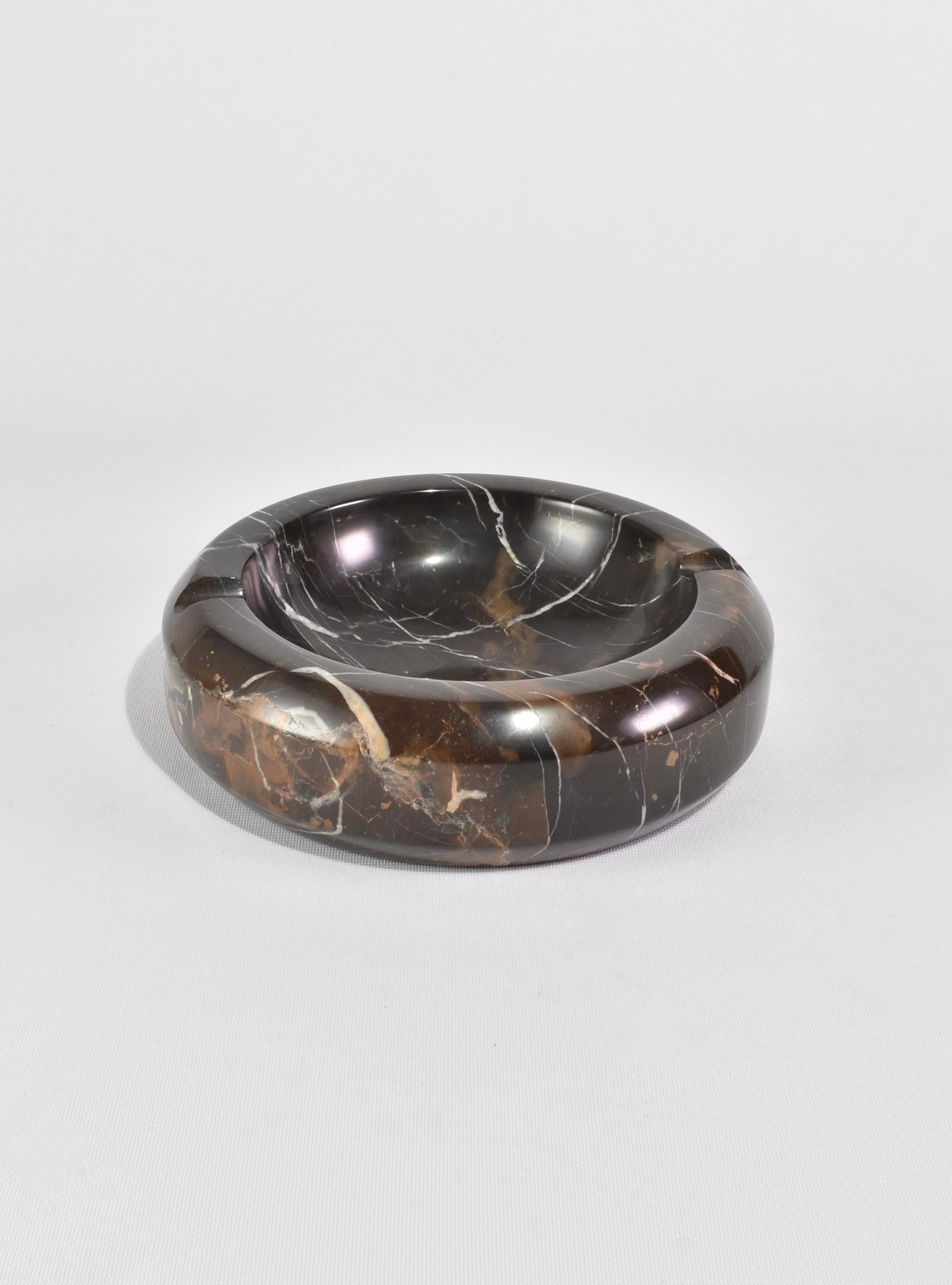 Large, round marble catchall or ashtray in shades of brown and black with white veining detail.