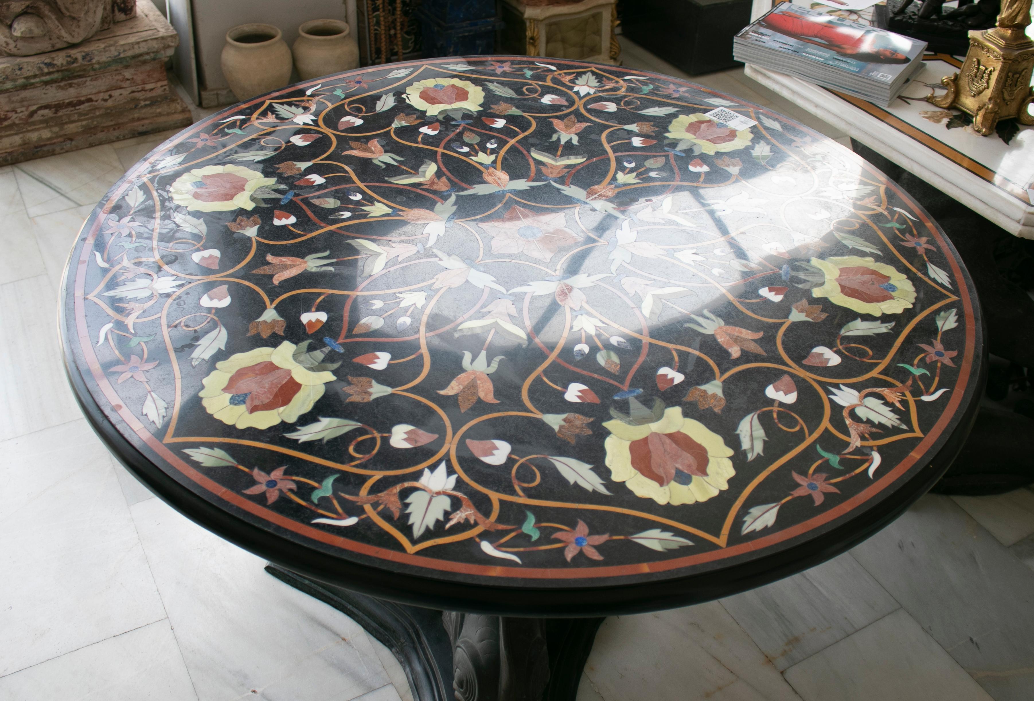 Round marble table top with hard stones mosaic inlay.