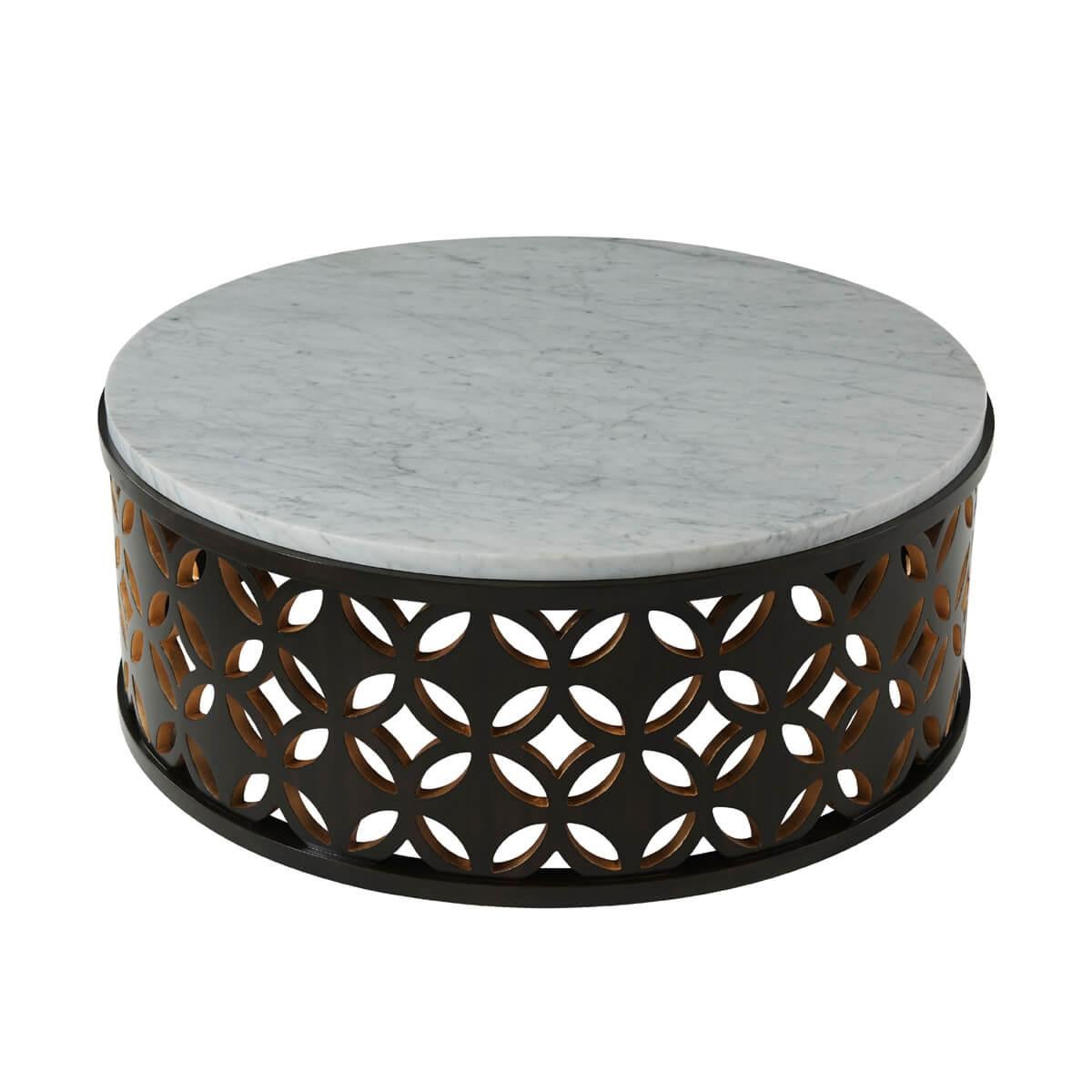 With an intricately designed reticulated wooden openwork base with gold leaf details supporting a round white bianco carara marble top.

Dimensions: 43.25