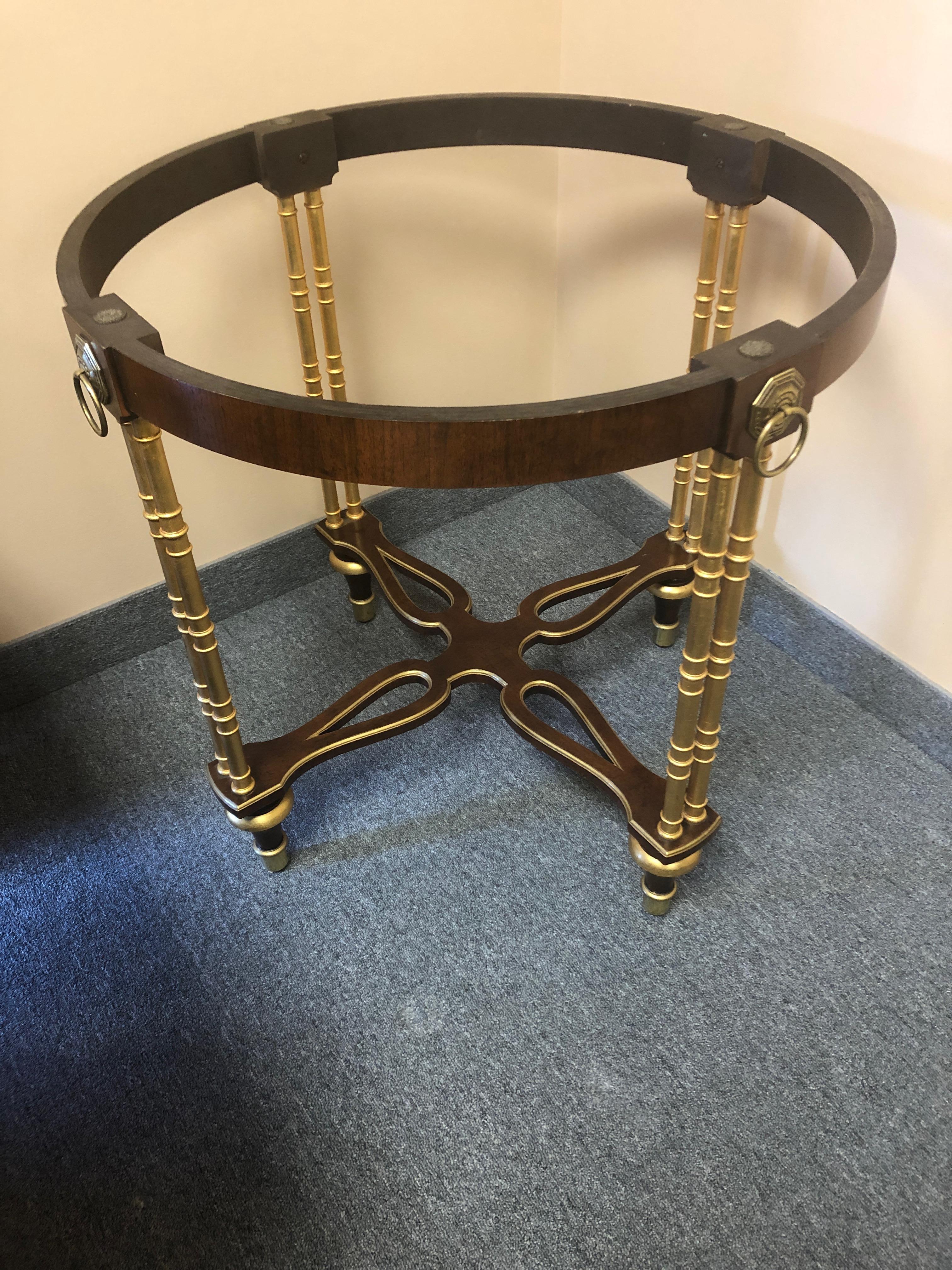 Medium sized versatile very elegant round side table having mahogany and gilded base with black and white marble top edged in brass.
Baker McMillan Collection label underneath.