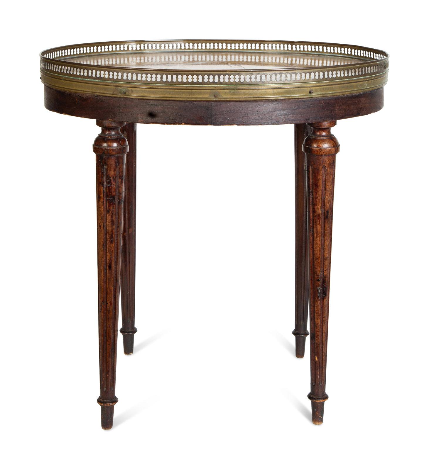Round marble top side table with a brass gallery and reeded legs, late 19th century.
 