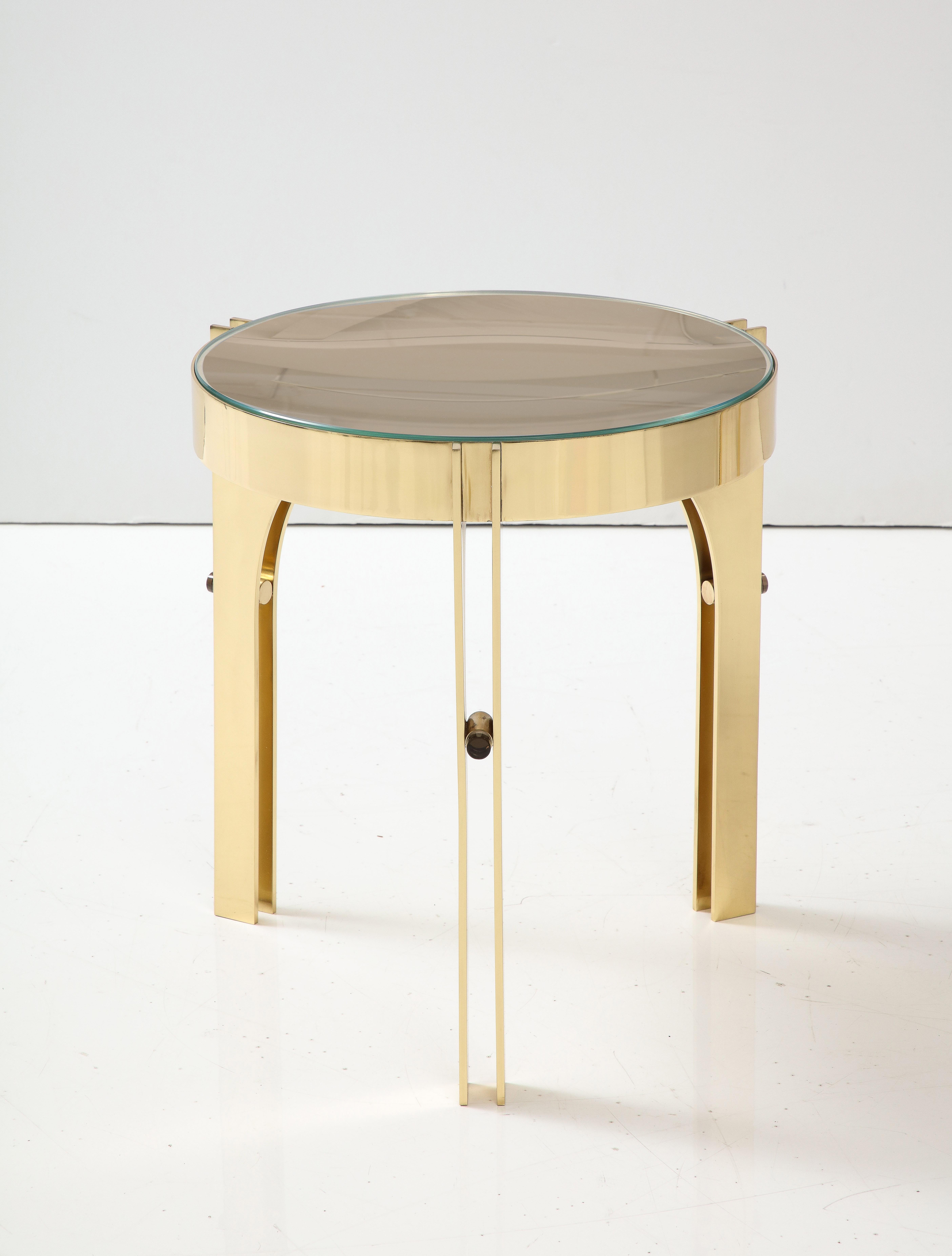 Bespoke and specially designed round martini drinks side table inspired by Max Ingrand Fontana Arte. This side table consists of a round structure in lacquered brass suspended by 3 architecturally designed brass legs. 12 mm round solid bronze glass