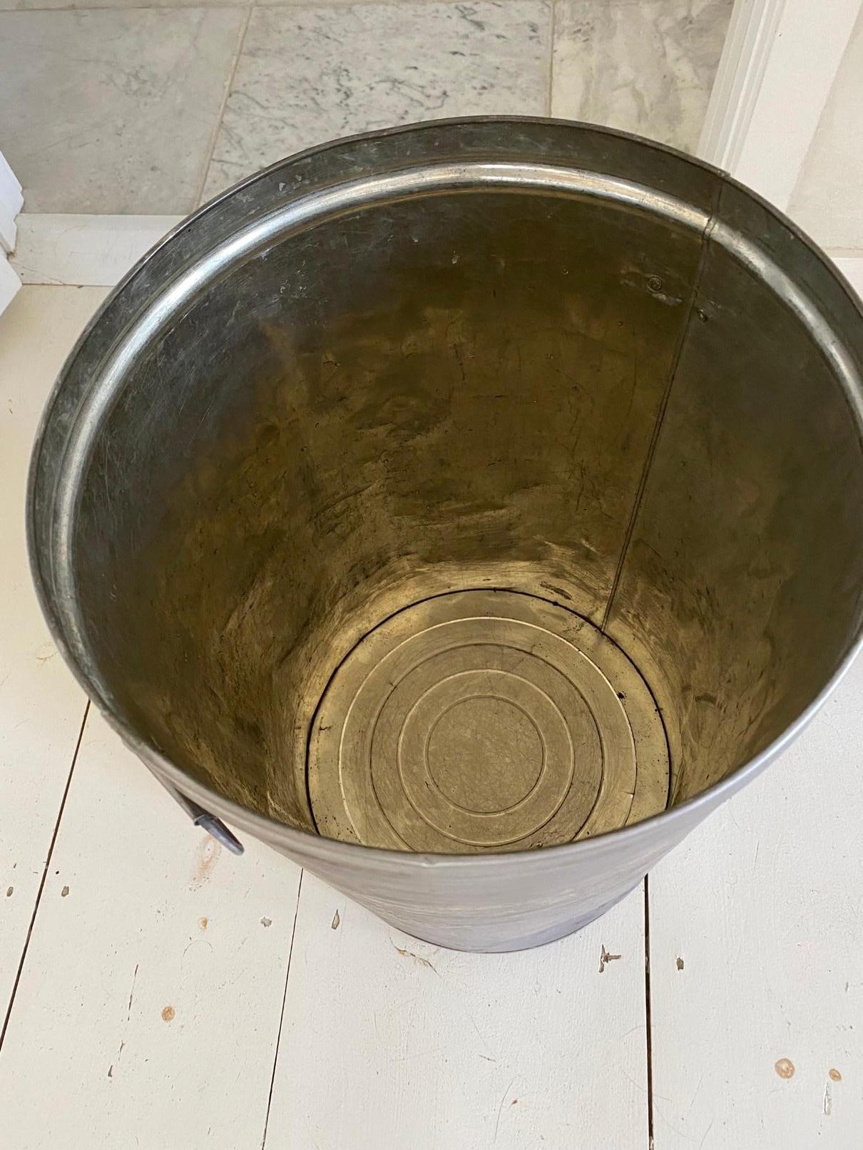 Rustic vintage iron grain storage vessel with a distressed pewter finish, aged patina and is a great industrial piece perfect for adding a little rustic farmhouse charm to any space. This galvanized metal bin is a perfect choice for adding interest