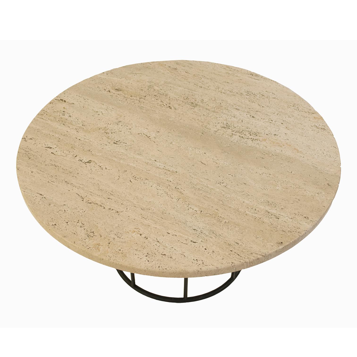 Round coffee/cocktail table after Arthur Umanoff in black wrought iron metal with original travertine top. Generously sized, it could easily lend itself to an alternative dining table for dinner by the fireplace. It is an attractive color