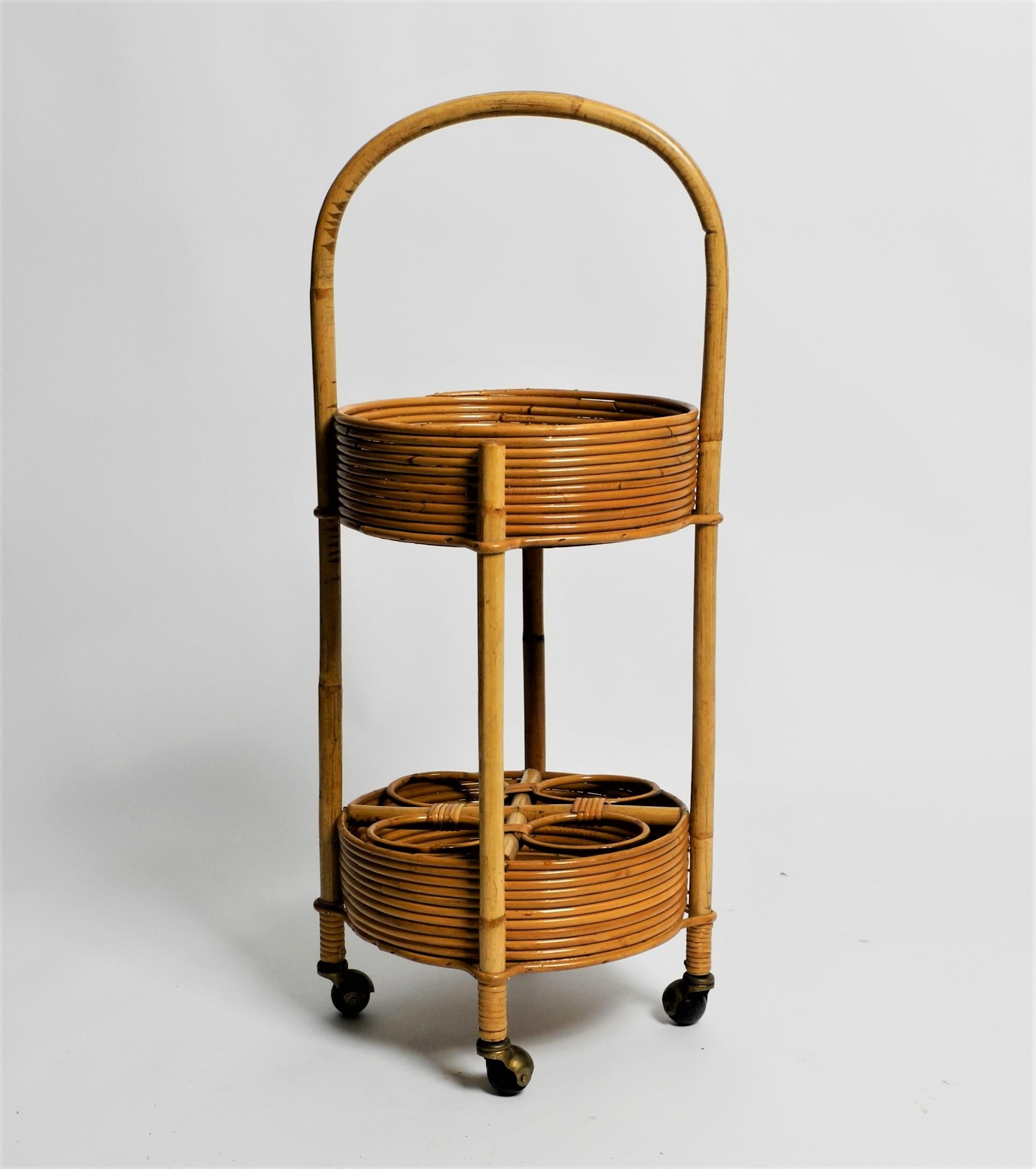 Vintage round rattan bar cart/serving trolley/rolling table on metal wheels with bottle holder, Italy, 70s.

Beautiful and practical small 1970s bar trolley with 2 trays. The bottom tray with 4 bottle holders. With a practical rounded carrying