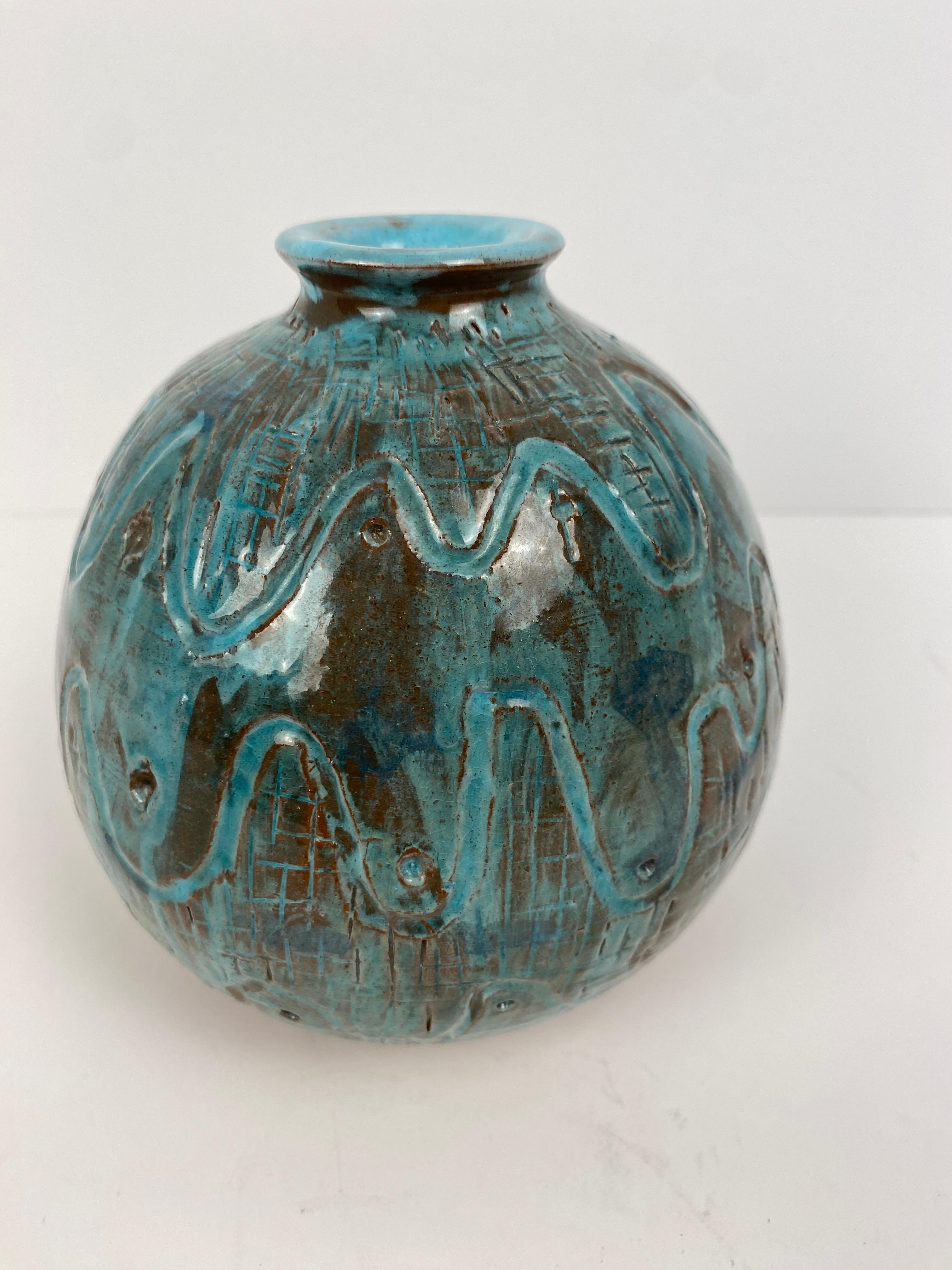 Mid-Century studio pottery ceramic vase, signed 

This hand-crafted ceramic vase is small in scale, yet, large in style. It embodies bold lines, stunning olive green hues with a black undertone. 
This signed piece of decorative art would enhance any