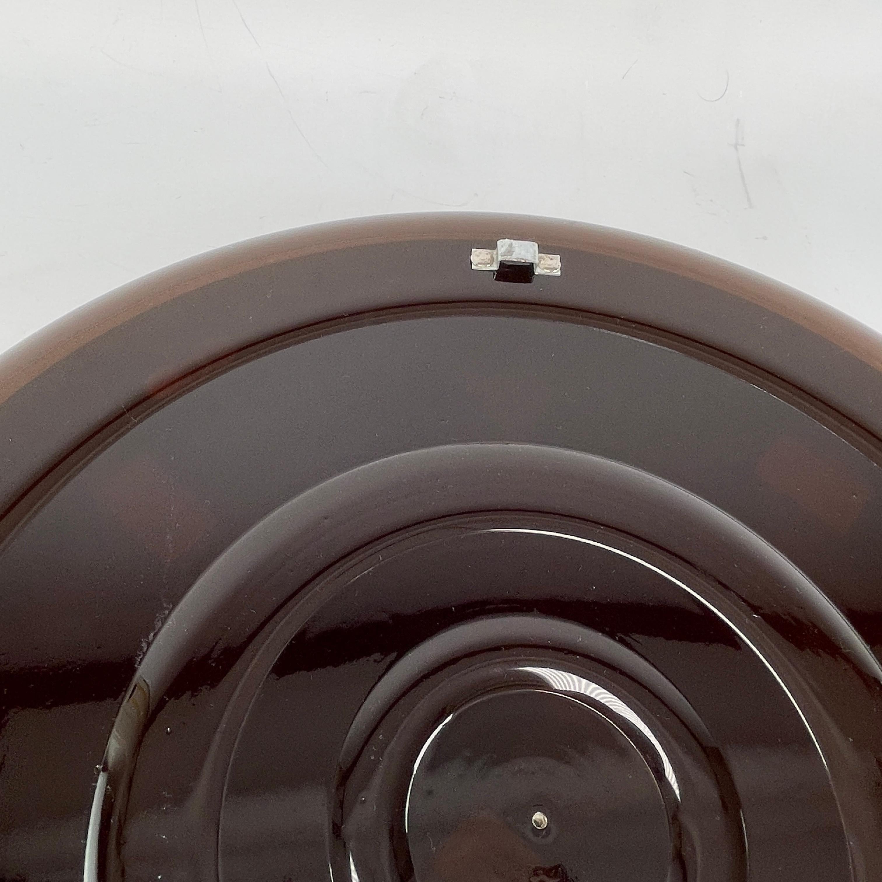 GUZZINI Mirror - 1960s

This stunning wall and vanity mirror is made from smoked brown acrylic and dates back to the mid-century. This incredible Guzzini mirror was made in Italy in the 1960s.

This stunning piece has a beautiful, round frame that