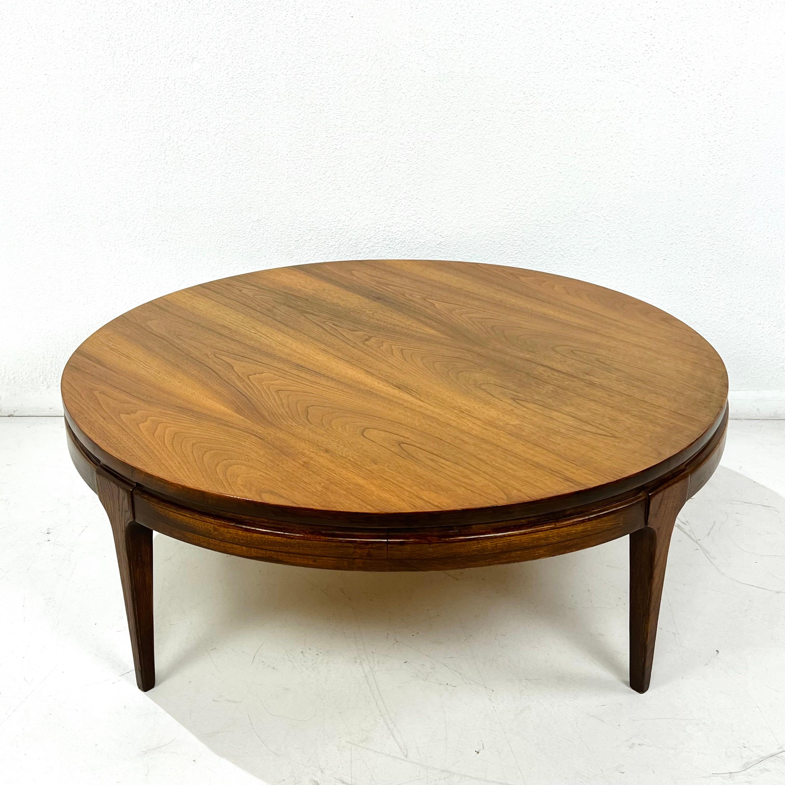 Sculptural round coffee table in the style of Lane's Pearsall-inspired Rhythm collection. Beautiful walnut top with a clean, classic look great for nearly any space or home. 

Good condition with some signs of cosmetic wear consistent with age and