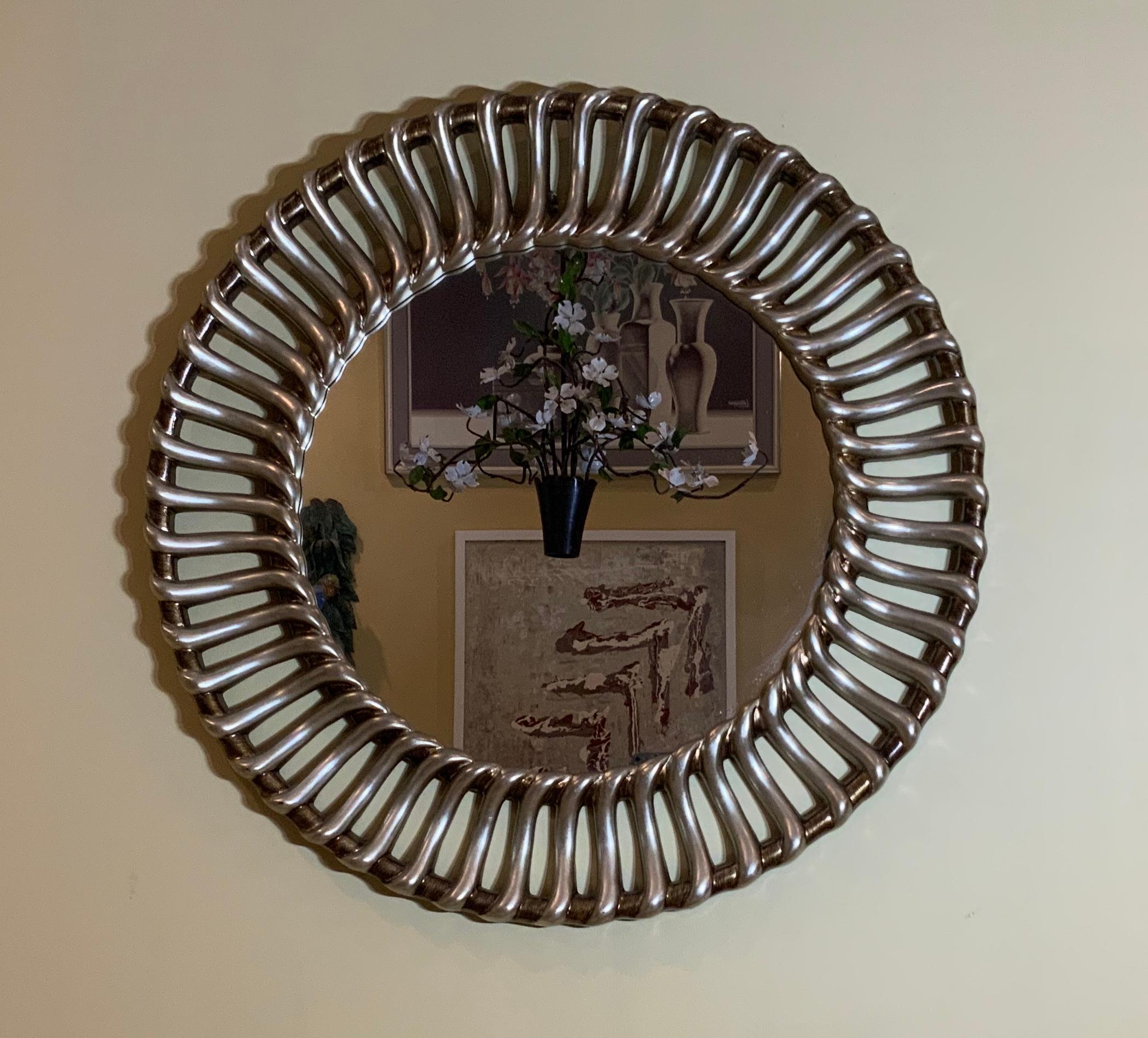 Elegant round mirror hand gilded with silver all around, great object of art for wall display.