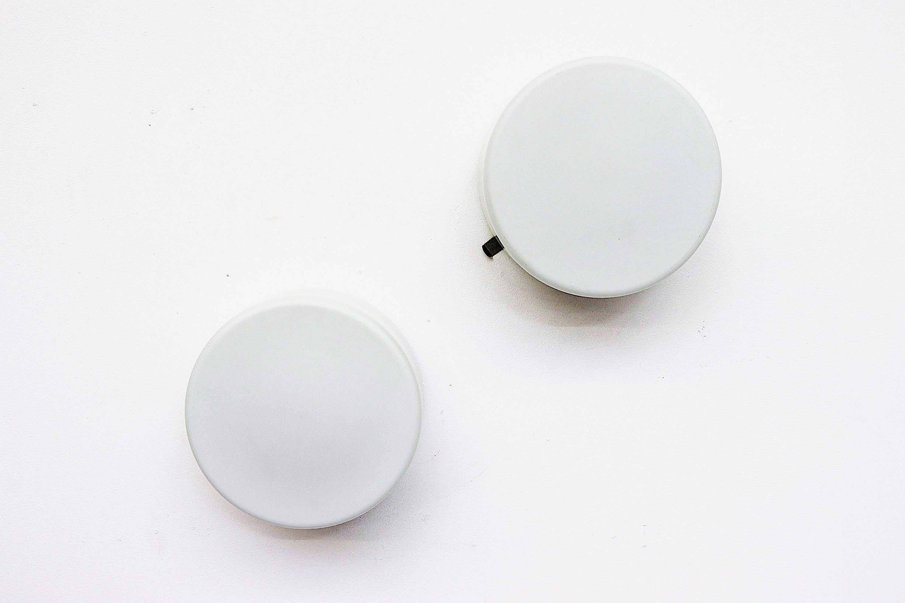 Phillips attributed pill box shaped flush mounted milk glass ceiling sconces or wall lamps. In good original condition with minimal wear and scratching.