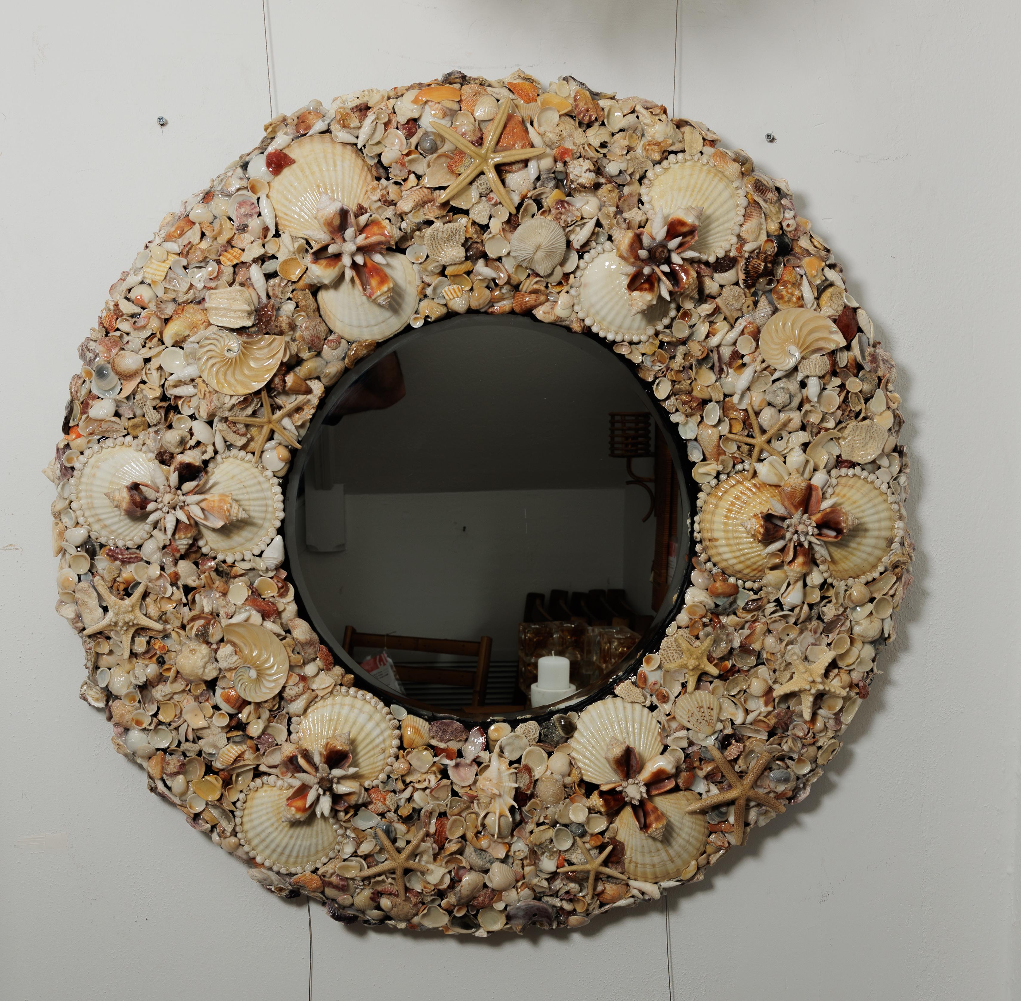 A beautiful round mirror covered in sea shells 