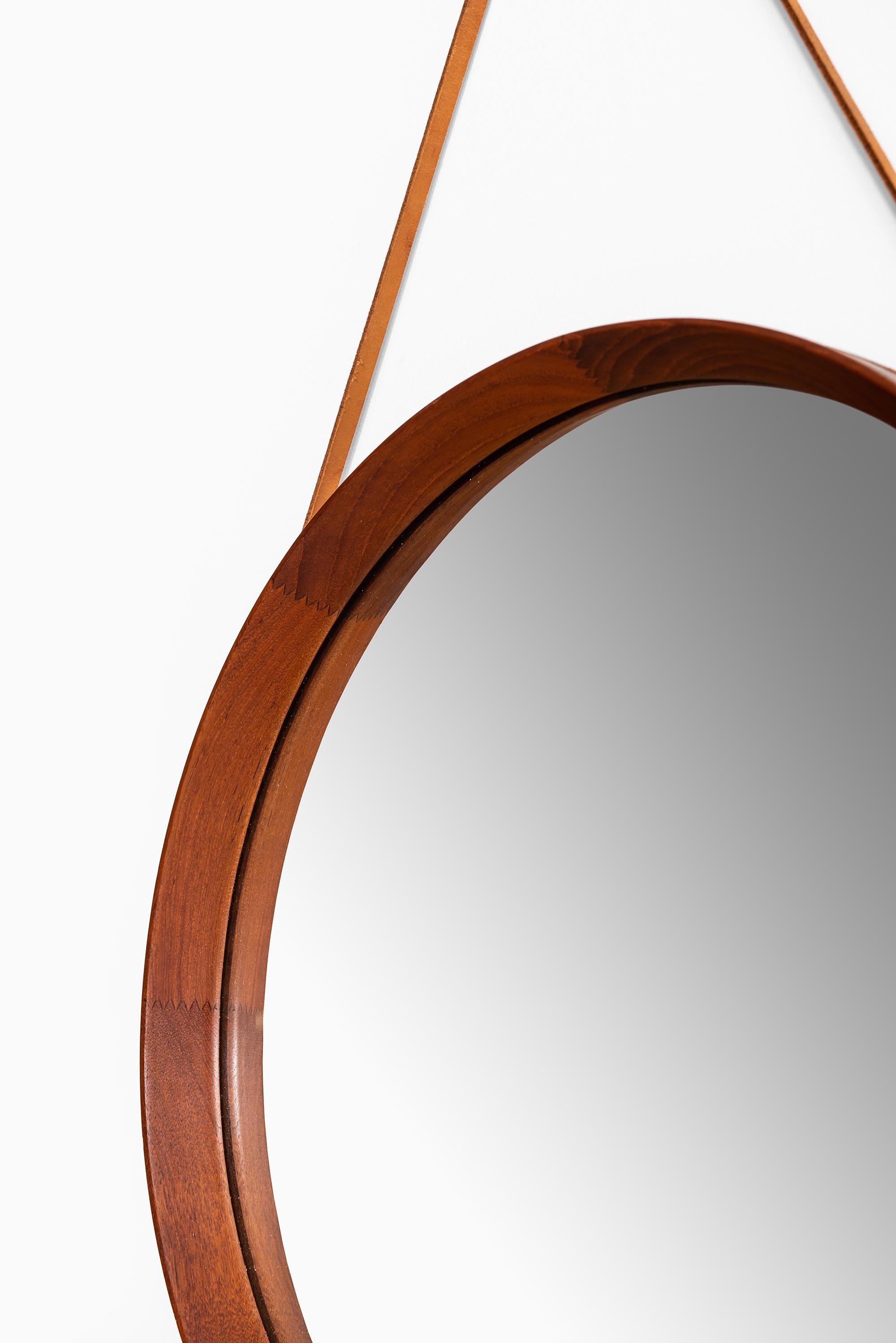 Rare mirror in leather and teak. Produced by Glas & Trä Hovmantorp in Sweden.