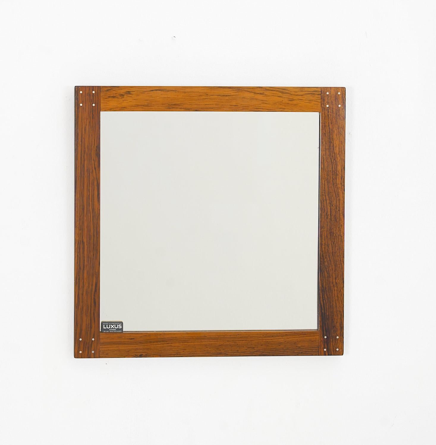 Swedish mirror by Uno & O¨sten Kristiansson for Luxus.
The mirror is made of rosewood with visible metal joinery in each corner.
Condition: very good original condition.