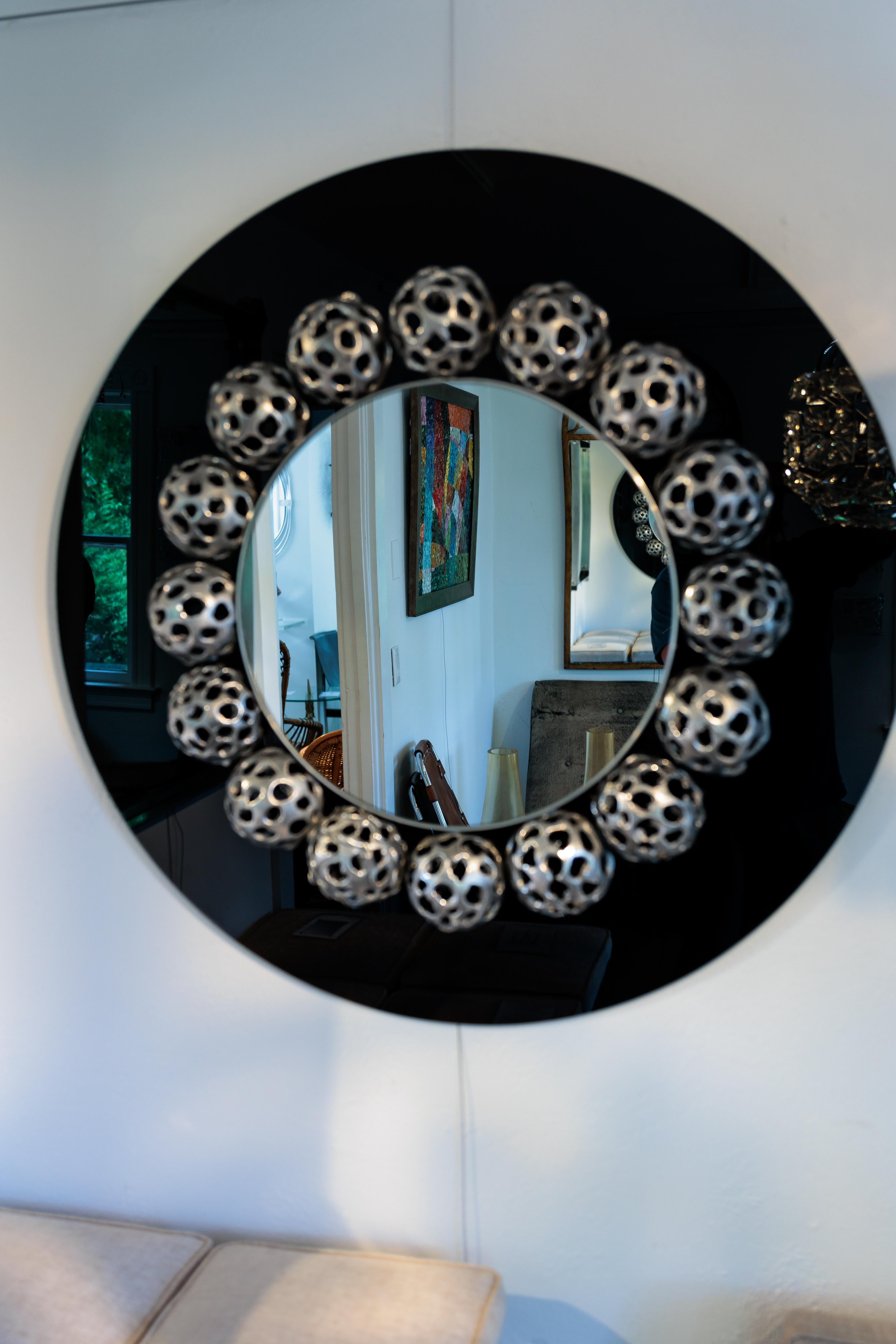 Round Mirror with 17 Metal Perforated Orbs on Black Glass In Good Condition For Sale In Bridgehampton, NY