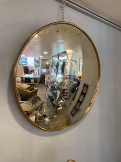 Miroir rond avec verre convexe et cadre simple en laiton