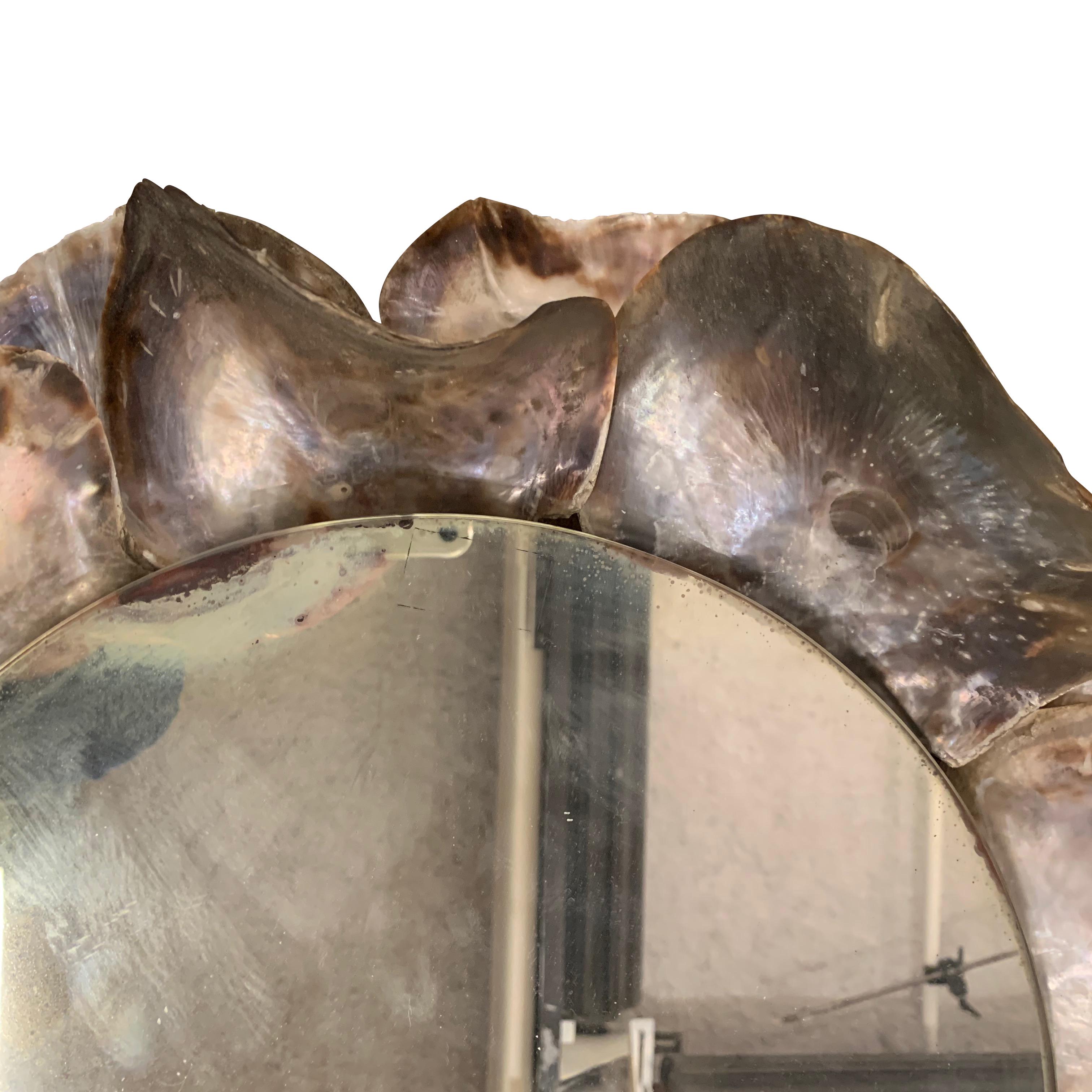 Layers of extra large mother of pearl shells form the frame of this round mirror
Very decorative.
  