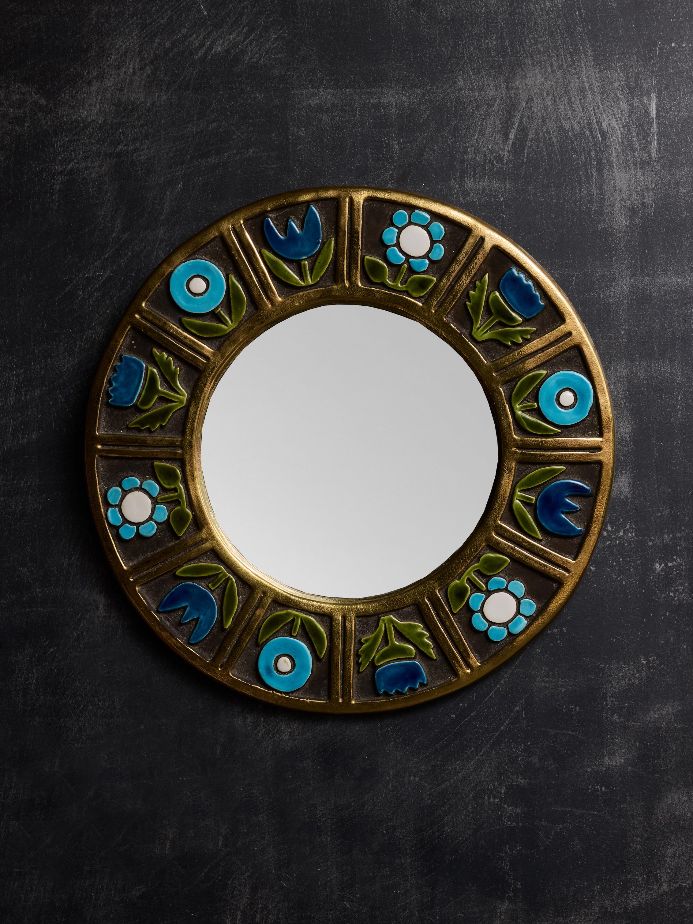 Round ceramic mirror by Mithé Espelt with debossed flower motifs in blue, teal, green and white glaze.

Marie Thérèse Espelt, aka. Mithé Espelt (1923-2020)

Born in the town of Lunel, near Montpelier; Mithé Espelt began her career in 1943 creating