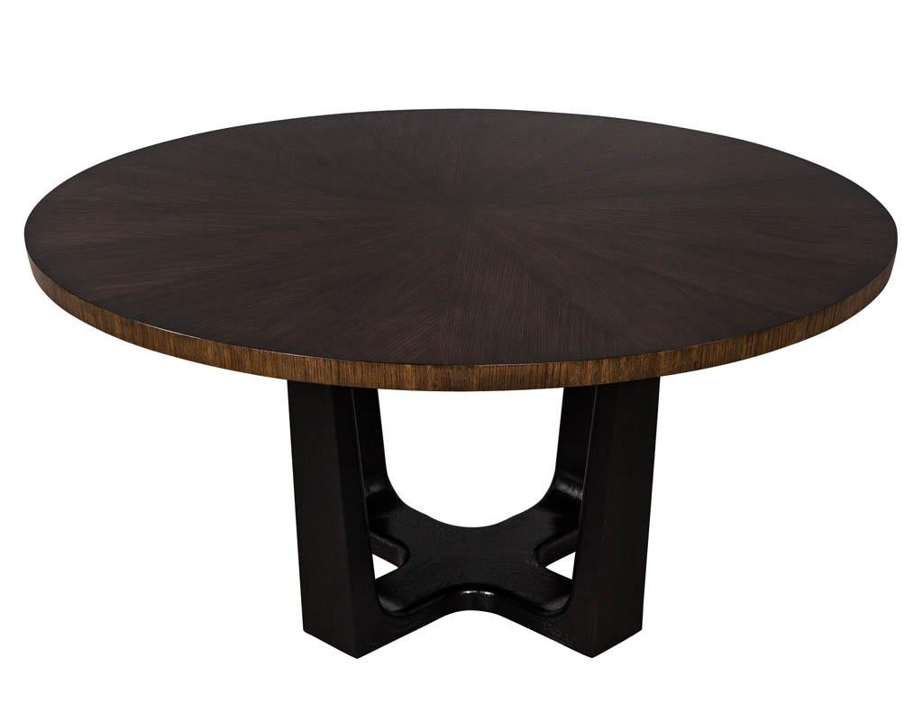 Round modern walnut dining table with sunburst top by Carrocel. Exquisite walnut sunburst top beautifully finished in a rich walnut perched upon a modern ebonized oak base. Newly made in Canada.

Price includes complimentary scheduled curb side