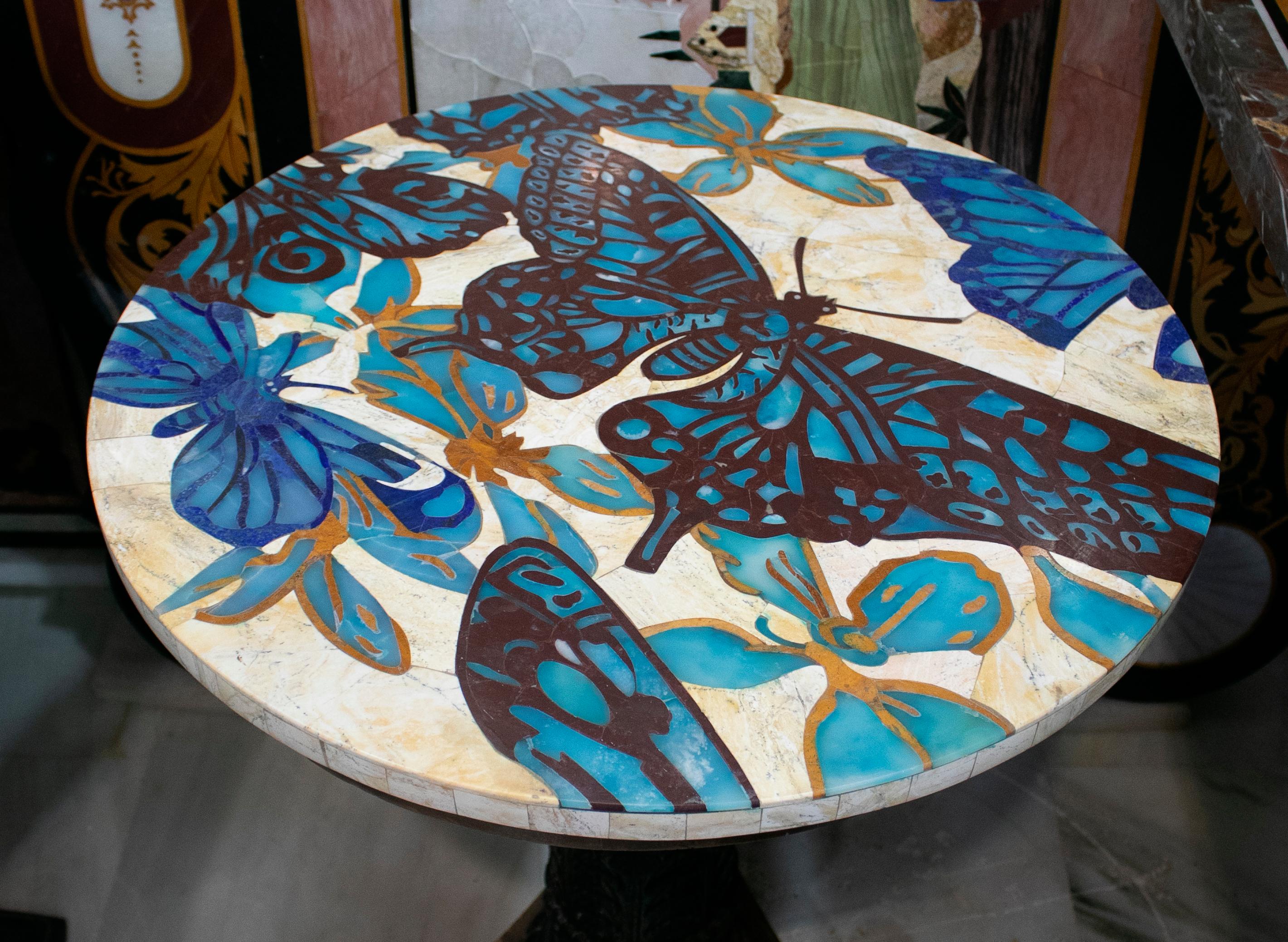 Round mosaic marble table top with butterflies and flowers inlay.