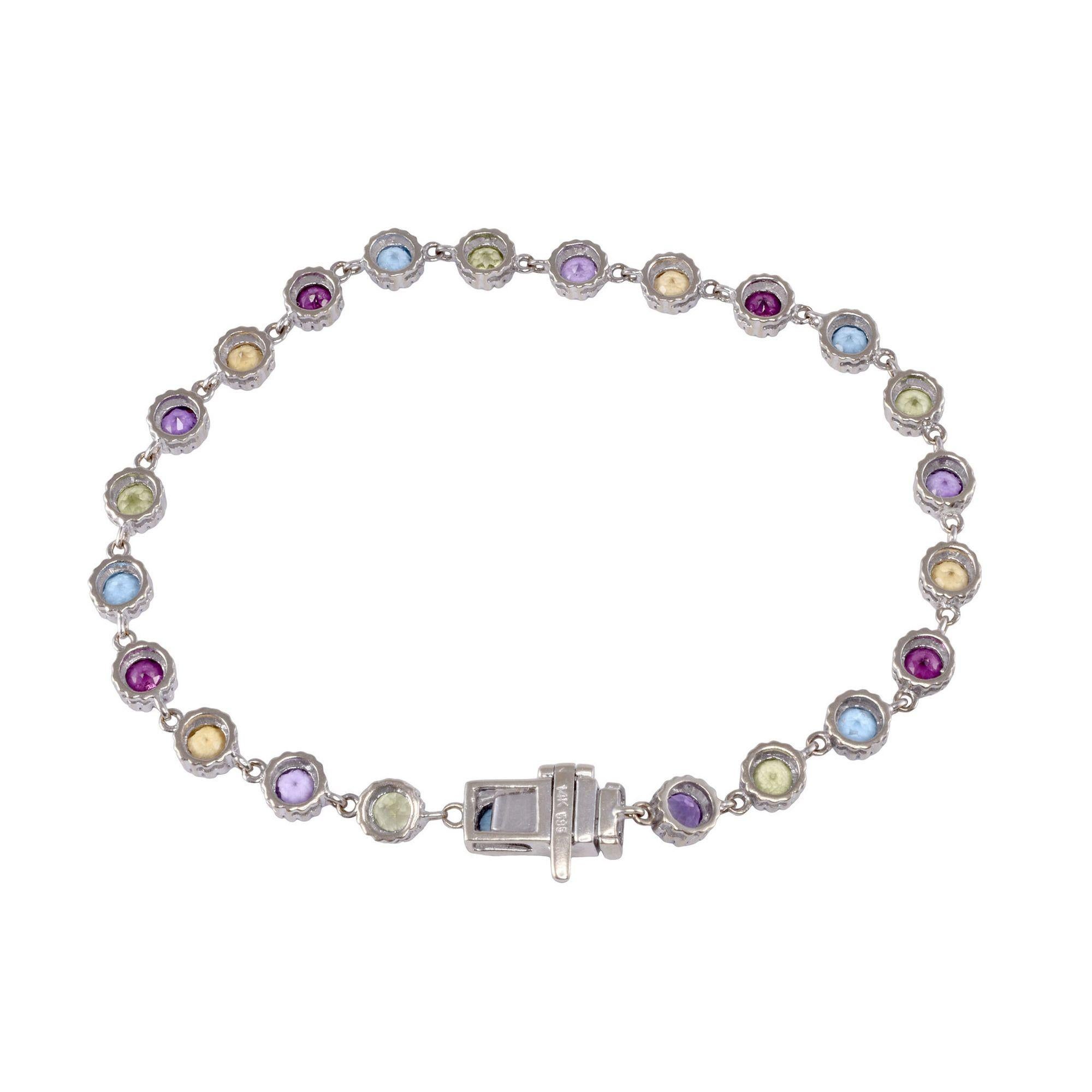 Estate round multi gemstone link bracelet. This 14 karat gold link bracelet features round gemstones including garnet, amethyst, peridot, citrine, and blue topaz. The bracelet also has a safety catch on the clasp. [KIMH 2144 P]
