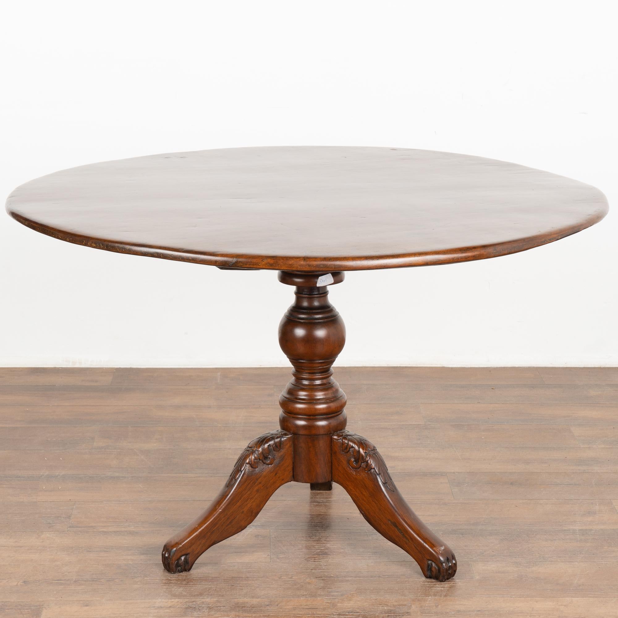 This pedestal table is a wonderful example of Spanish colonial design. The stunning top is made from a single piece of Narra wood and rests on decoratively carved tripod legs.
This pedestal side table is just under 4' round, is restored, solid and