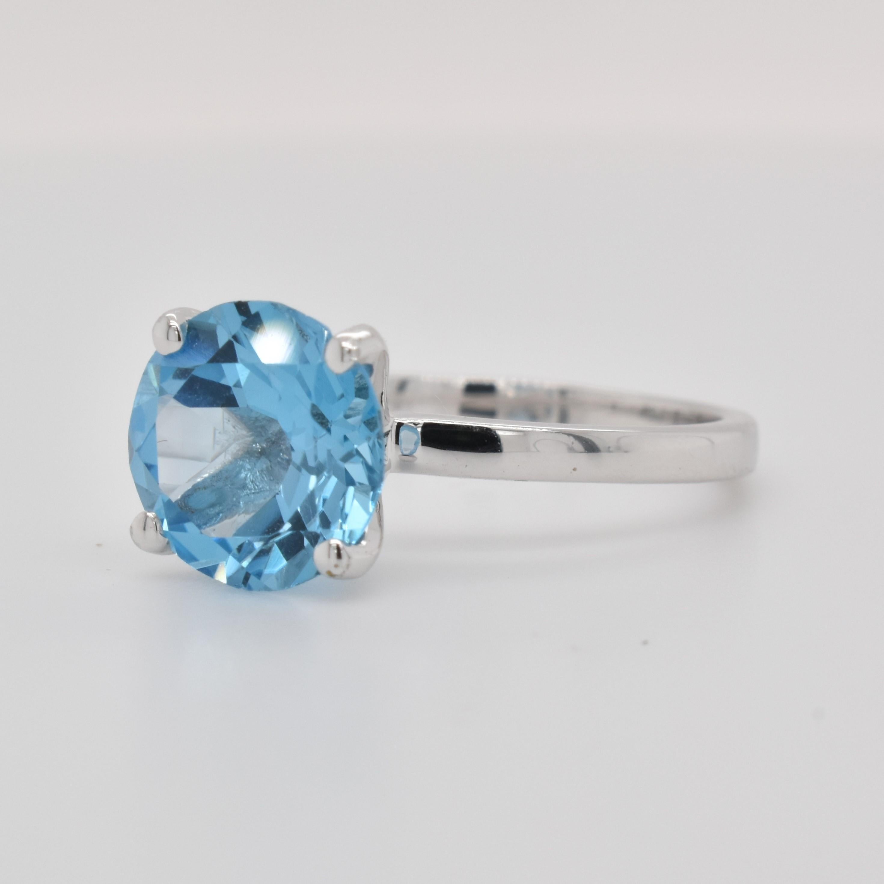 Round Shape Swiss Blue Topaz Gemstone beautifully crafted in a Ring. A fiery Blue color December Birthstone. For a special occasion like Engagement or Proposal or may be as a gift for a special person.

Primary Stone Size - 9x9mm