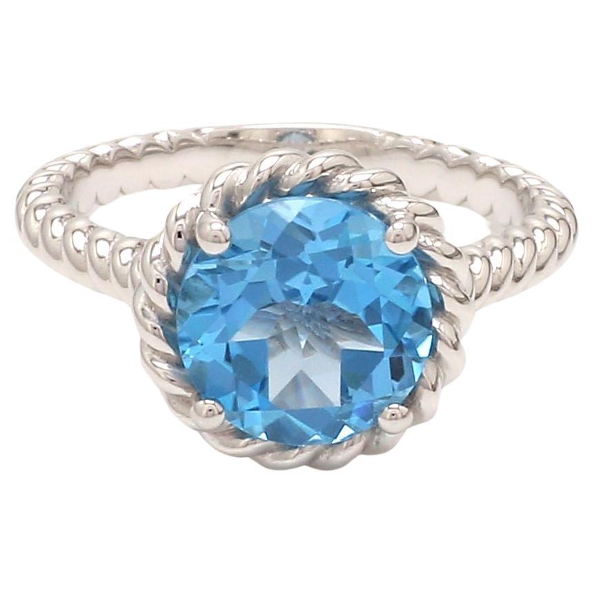 Bague ronde en rhodium sur argent sterling avec topaze bleue naturelle suisse