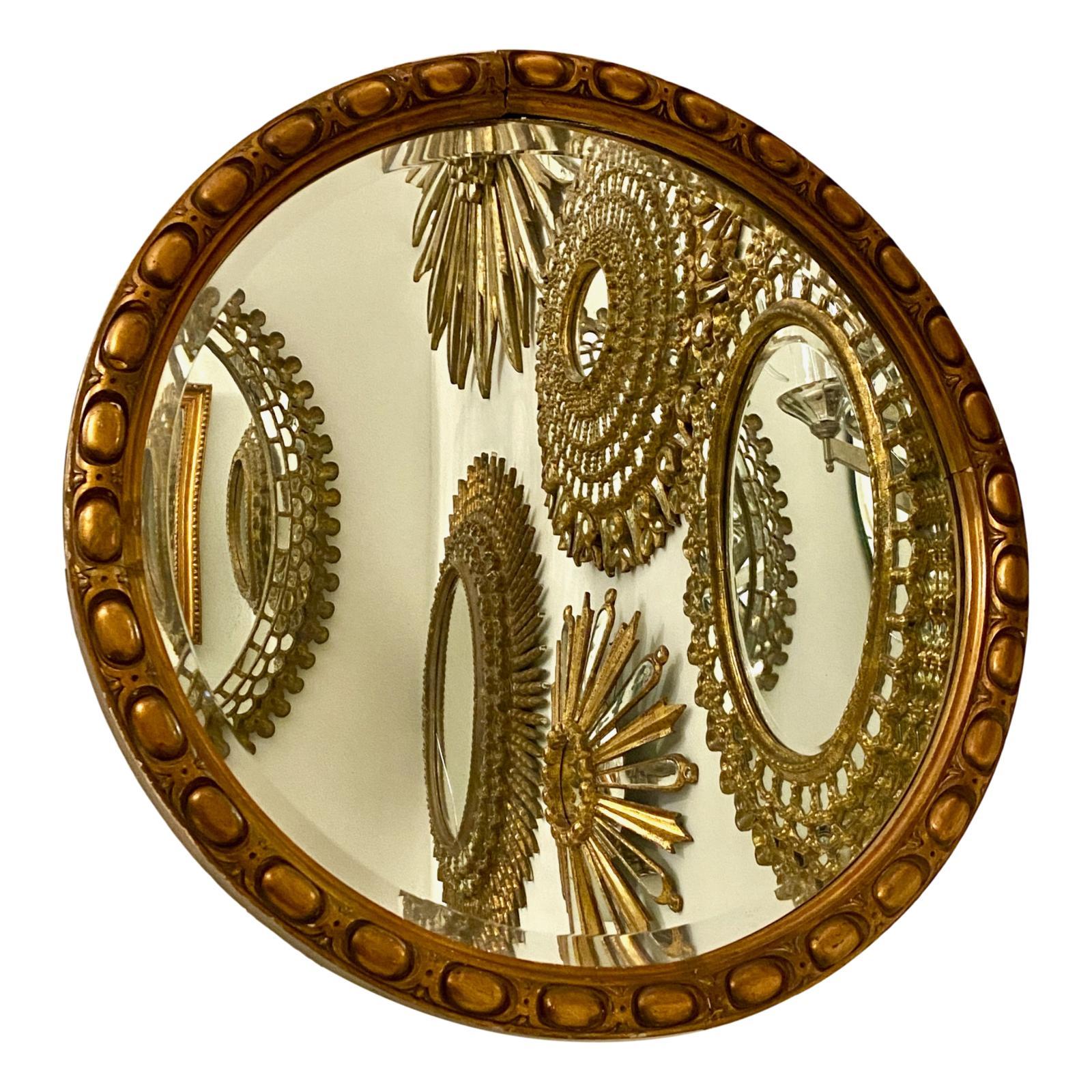 A circa 1900 Italian neoclassic style carved and gilt wood mirror with original finish and patina.

Measurements:
Diameter: 33.5
