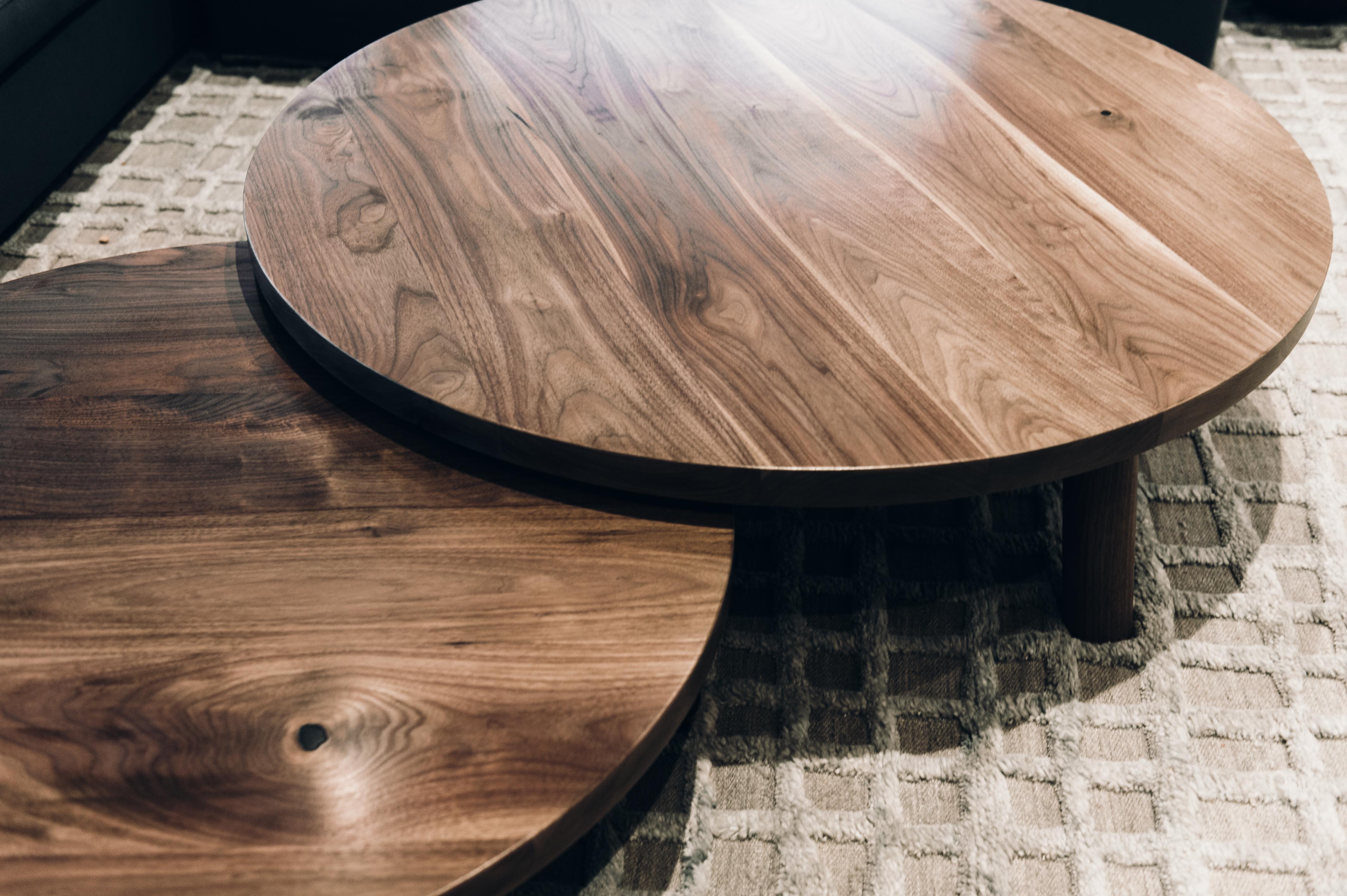 A fluid set of coffee tables that will adjust to any room or scenario thrown their way. These are handcrafted from thoughtfully sourced local walnut and built by our team of artisans. Each table features 3 legs are turned in by us in house. They