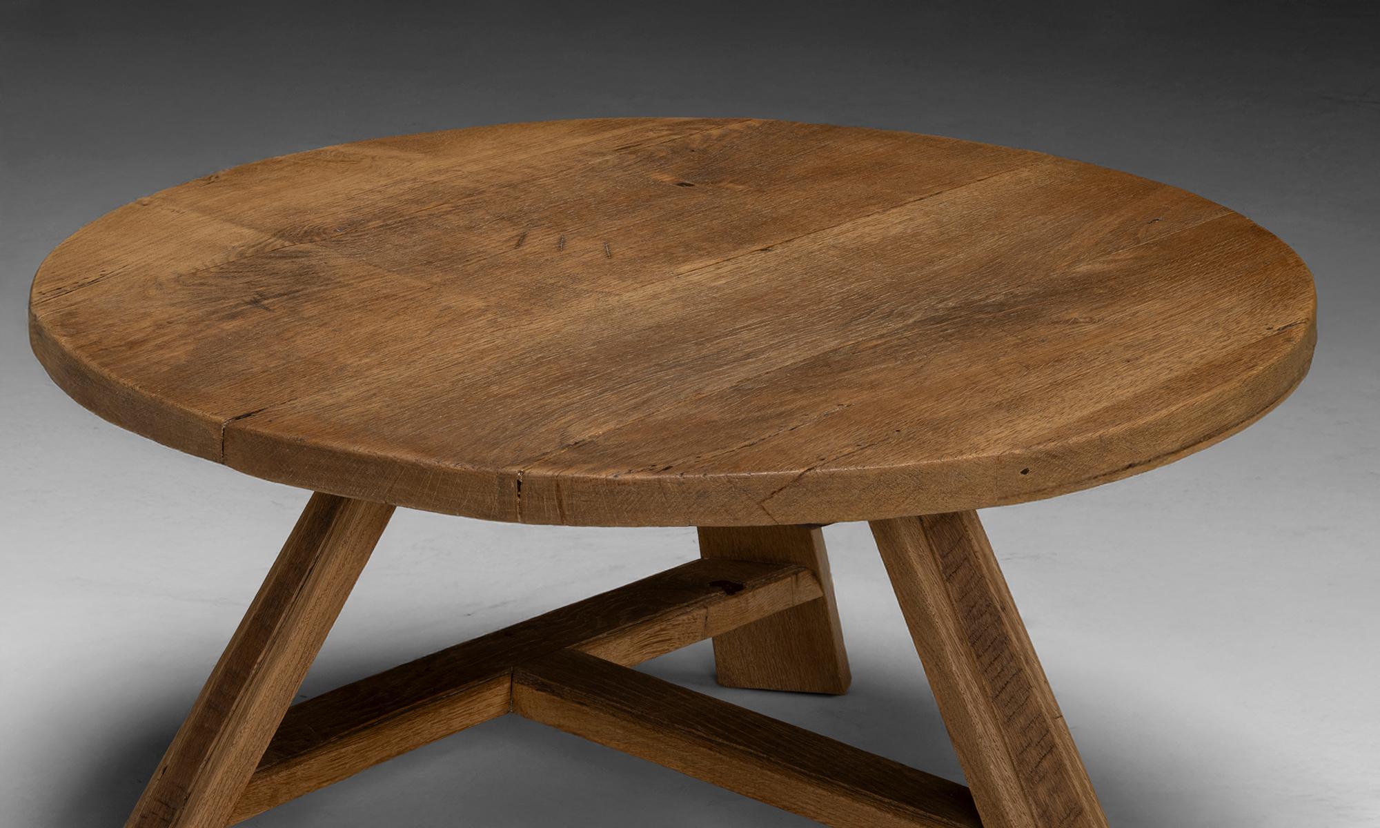 Belgium, 1960
Brutalist round oak coffee table, with angled flat tripod legs.
35