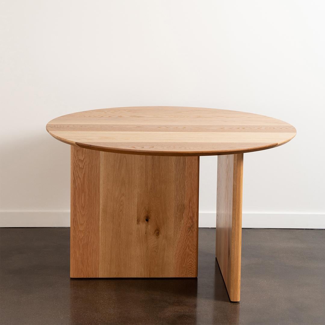 This solid round oak table was designed in collaboration with The Franco Company based in Dallas, Texas. This piece can be used as an entry table or dining table that comfortability seats four. 